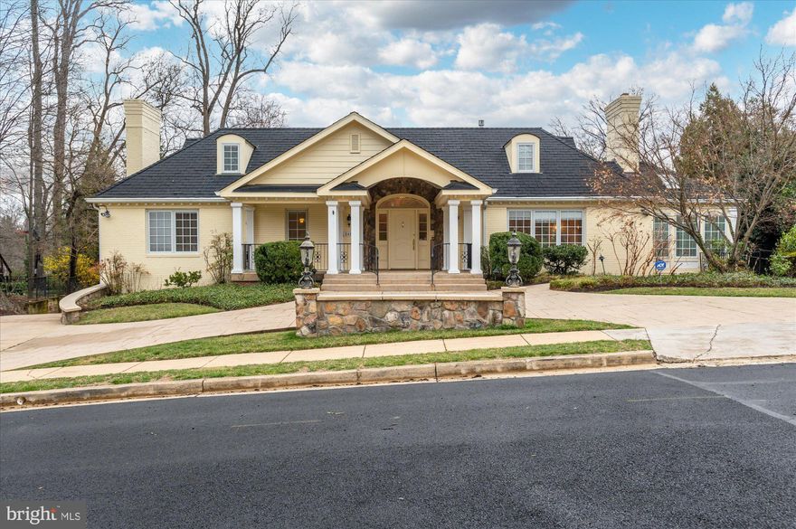 Step into this beautifully appointed and sought after Country Club Hills custom home of unparalleled quality in a 2005 expanded version of a ranch style home. A perfect Arlington location, it is just one light from DC providing access to transportation, shopping and fine dining. Sprawling with large, spacious rooms, it is ideal for grand entertaining, as well as, comfortable family living. From the entry foyer begins the journey into a long gallery, past the convenient elevator and into the main living areas. The Lobkovich kitchen was renovated and updated with superior quality in 2005 and still maintains charm and great function with a Sub-Zero Refrigerator and other high-end appliances, granite counters, and a kitchen island. Adjacent to the Kitchen and Breakfast Area is the Sunroom, beaming with natural sunlight and access to a deck, just one of the two outdoor entertaining areas. Walk around to the expanded Family Room, beautifully light and open and hosts views to the lovely private, wooded and very rare, almost one-half acre lot. Through French Doors step into the main Great Room/Living Room, central to the floor plan, with another Fireplace, just one more example of the large expanded rooms in this beautiful, gracious home. Let us not forget the expanded, walk-up  Attic, perfect for finishing into another prime area for living. The Spacious Primary Bedroom is on the first floor and features a large walk-in closet and Luxury Primary Bath with separate shower and tub. There is a Second Bedroom on this level with another En-Suite Bath and a Powder Room. The Lower level features a large Recreation Room with Two Additional 
Spacious Bedrooms and two full baths with another Kitchen, perfect for an In-Law or Teen Suite.
Walk out from this level onto an enormous Slate Paved and Stone Fenced Veranda overlooking the private backyard retreat in this lovely treed and professionally landscaped, and again, rare .44 Acre lot.
Additional features include an Elevator to the Garage, Radiant Heated Driveway, Whole House Generator and a Two Car Garage and Semi-Circle Front Driveway with lots of additional parking, a lovely Front Porch and a New HVAC System in 2022. 
The area is walkable to wooded parks and is in the highly rated Jamestown Elementary, Williamsburg Middle and Yorktown High School tier.