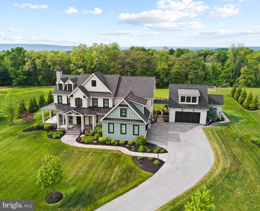 Standing on two acres is this stunning five-bedroom, 4,900 square foot home with a three-car garage, plus the added bonus of a separate 800 square foot, two-bedroom guest house with a two-car garage. Custom built by Harrisburg-based FoxBuilt in 2019, the property is magnificent inside and out with an in-ground pool, spacious back patio, fire pit, covered front porch, and beautiful landscaping. Skillfully crafted, you’ll appreciate every high-quality detail, including gorgeous hardwood floors, wainscoting, brick accents, ship lap, and exposed beams, all giving this exquisite property a warm, modern farmhouse feel. The first floor of the main house includes a gourmet kitchen/dining area that provides a high-end professional six-burner gas range with griddle, two dishwashers, huge breakfast island with seating, and a fantastic walk-in pantry. A convenient butler’s pantry joins the kitchen and formal dining room. The main floor also hosts a bright sunroom with a vaulted ceiling that opens to the patio area. Ideal for working from home is a first-floor office with built-ins, and upstairs there’s a second office off the primary bedroom. Offering a quiet retreat, the primary bedroom also includes a sitting area, large walk-in closet and attached private bath with dual vanities, soaking tub, and walk-in tiled shower. Four additional bedrooms and two Jack and Jill baths are located on the second floor. In one of the bedrooms, you’ll find four wonderful built-in bunk beds. If you enjoy exercising at home, the lower level hosts a finished gym area that also has walkout stairs to the back patio. There’s plenty of unfinished storage space in the lower level too. Rounding out the property is a wonderful guest house with two bedrooms, full bath, living room, kitchen, and an attached garage for two cars. The extra space is perfect for in-laws, family, visiting guests, or can be used for quiet office space. Don’t miss the opportunity to see this dream property in person!
