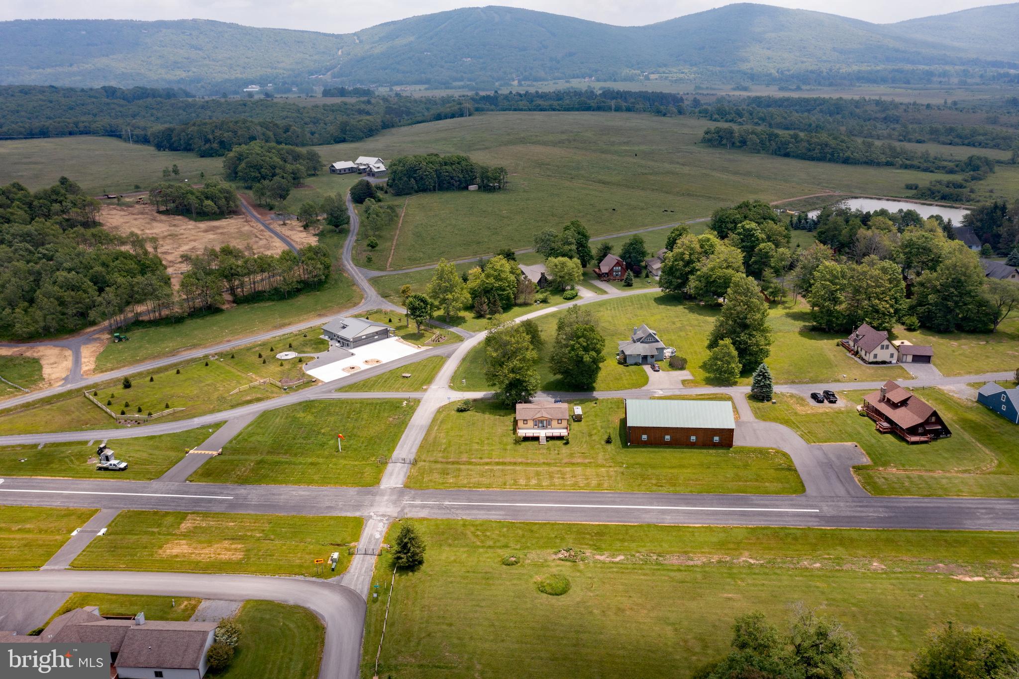 Windwood Fly-In Resort offers an exceptional opportunity for those seeking a full-time residence or second home in the picturesque Canaan Valley of West Virginia. Conveniently located in the heart of this stunning area, the resort boasts a private 3000 by 40 ft paved runway, providing easy access whether you prefer to drive or fly in. With ample tie-down parking available, as well as the unique option to taxi and park directly at your front door or into your private hangar, Windwood ensures convenience and flexibility for its residents.
Lots 14, taxiway accessible, offer prime locations within the resort. Residents also have access to a community pool, perfect for relaxing and enjoying the surrounding natural beauty of Windwood.
The Canaan Valley itself is renowned as a Four Season Paradise, offering breathtaking views of the Allegheny Mountains and a wealth of year-round activities and adventures. From skiing in the winter to golfing in the summer and fall at nearby Canaan Valley Resort, there's always something to do.
Moreover, the valley is surrounded by National Forests, Wilderness Areas, State Parks, and renowned rivers ideal for whitewater activities and sport fishing, providing endless opportunities for exploration and outdoor enthusiasts.Windwood Fly-In Resort sounds like an incredible place to live, especially for those who love the combination of aviation and natural beauty.
The ability to fly directly to your doorstep or park in a private hangar is a unique and appealing feature, offering both convenience and luxury. The resort's location in Canaan Valley, surrounded by mountains and forests, provides access to countless outdoor activities throughout the year. Whether you're into skiing, fishing, golfing, or simply enjoying the serene environment, it seems like there’s always something to enjoy.