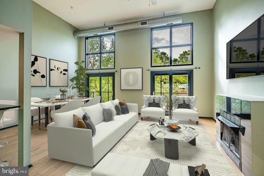 Welcome to 182 Gay Street, Unit 606, a rare opportunity to own a spacious bi-level condo in the highly sought-after Nob Hill community of Manayunk. Perfectly situated just steps from Main Street, this home offers the convenience of city living while tucked away in a quiet, tree-lined neighborhood setting. This exceptional 2 bedroom, 2 bathroom condo features soaring 16-foot ceilings and dramatic floor-to-ceiling windows that fill the space with natural light. The open concept living, dining, and kitchen areas are ideal for entertaining, with two sliding glass doors that open to a private Juliet balcony offering peaceful neighborhood views. The kitchen is equipped with granite countertops, stainless steel appliances, ample cabinetry, and a breakfast bar for casual dining. Down the hall, you will find a full bathroom with a jacuzzi tub, a laundry room with full-size washer and dryer, and a spacious second bedroom with generous closet space and large windows. The primary suite offers additional closet space, oversized windows, and an en-suite bathroom with a walk-in shower. A spiral staircase leads to an oversized loft space that is perfect for an additional bedroom, home office, or recreation area. Beyond the loft is the crown jewel of this home: your very own private rooftop deck. Recently updated and one of only a few units in the community with this feature, the rooftop space offers sweeping views of Manayunk and the city skyline—an ideal retreat for relaxing or hosting guests under the stars. Additional features include two assigned parking spots in the private lot and a gas fireplace with granite surround. With easy access to the Manayunk train station, I-76, I-476, Center City, and the suburbs, this home combines comfort, location, and lifestyle in one stunning package. Do not miss your chance to own this unique property in one of Manayunk’s most desirable communities. Schedule your showing today! Please note: Photos have been virtually staged to showcase potential furniture layouts and design ideas.