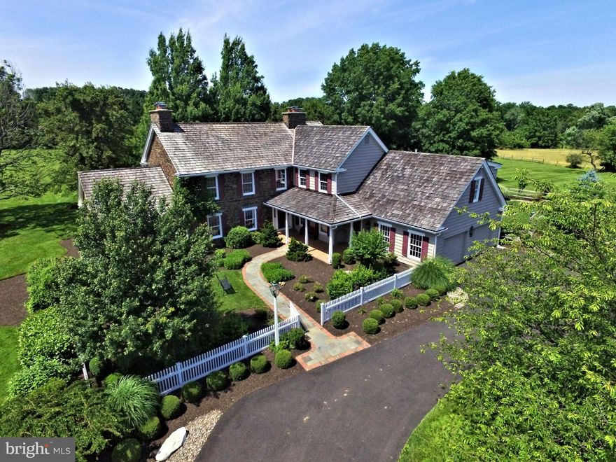 Sited perfectly on an absolutely spectacular 6.55 acre parcel, this custom built home offers everything that a special Upper Makefield estate property should - quality built with attention to design details,  amazing location,  one of a kind unique layout with generously sized rooms and smart floorplan, neutral, stylish and understated charm,  immaculate grounds, the ultimate in privacy, and many amenities for active living in an incredible setting.  A gorgeous stone / cedar front impresses as you enter from the long governors drive. The foyer entry reveals beautiful oak hardwood floors, living room and office to left. Both rooms feature fireplaces; the office has built-ins and exit to a private patio; the living room boasts extensive moldings and raised paneling. To the right is a cozy family room with exposed beam ceiling, stone fireplace, wet bar and exit to the large covered patio and pool area.  The large gourmet kitchen features designer appliances, two dishwashers, cherry cabinets, granite counters, center island, large walk-in pantry and more. The expansive breakfast / dining  / lounge area with volume ceiling offers walls of windows with great views, back staircase,  and exit to the pool area as well. A second family/great room offers additional entertainment  and flexible space.  Laundry, powder room, and garage entry complete the first floor. The upper level features a luxurious and spacious Master Suite. The bedroom has gorgeous built-ins and fireplace, two giant walk in closets, second laundry. The bathroom has a large steam shower with multiple sprays, jetted tub, marble counters, tumbled stone flooring with radiant heat, and elegant cabinetry. Bedroom two is ensuite, and has an adjoining loft for use as a second private home office. Bedrooms three and four share a hall bath. The third floor is finished as Bedroom five, with ample closet space, well appointed bath and triple bay window. The lower level offers generous finished space for entertainiment and gaming, and features ample storage. The barn/outbuilding offers a third garage bay, ample storage, floored attic, and large finshed conditioned space for gym, flex, or entertainment. Outside, the amenties list is long - gorgeous Anthony Sylvan saltwater gunite pool and spa, built-in outdoor grill, full sized lighted tennis / sport court with basketball hoops, storage shed and more. There is a whole house generator and secuirty system  for safe keeping, 4 zone HVAC and more. The flat stunning land is immaculate with not a blade of grass out of place, flowering gardens, flagstone and brick patios, long vistas, with three sides of the property ringed by unifom and magnificent Douglas fir and White pine trees. All in all, this beautiful home and property represent the best value on the market today in the Council Rock School District. Located just minutes from I-95 and Jersey bridges, 10 minutes to Trenton Mercer Airport, 10 minutes to lively Newtown Boro, and 15 minutes to New Hope Boro -and yet a world away from everything...