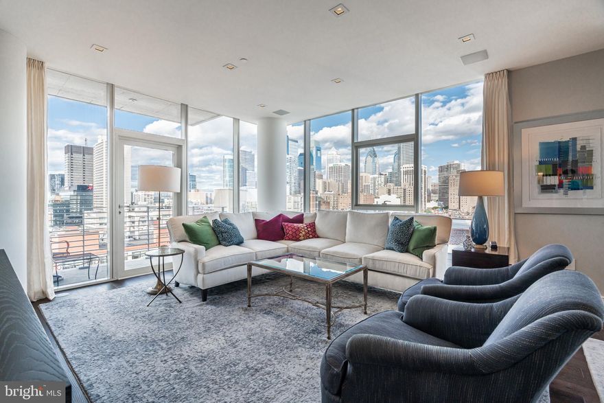 Rarely-offered 4-bedroom, 4.5-bath at One Riverside Condominium with spectacular panoramic views, two terraces and 2 parking spaces. New wood floors throughout, 10' ceilings with custom Lutron window shades and lighting. This beautiful home features an entry foyer, large coat closet, and wall space for displaying an art collection. Spacious and bright eat-in kitchen with North, South and East views of Skyline and Schuylkill River. Kitchen includes Wolfe and Sub-Zero appliances, Quartz countertops, beverage refrigerator, wall oven and microwave, and South- and East-facing terrace. Open dining and living room with North-facing skyline view and additional terrace. Main bedroom suite with 2 walk-in closets and 4-piece bath with soaking tub. This home also features a Miele washer & dryer, speaker system and custom closets by Closets by Design. This sale includes 2 valet parking spaces in the underground garage ($295 monthly fee per car). The building is adjacent to the 60-mile Schuylkill River Trail, recently named best urban trail in the nation, and next to Schuylkill River Park, which has two dog parks, tennis and basketball courts and Markward Playground. One Riverside is an award-winning luxury condominium with full-service amenities, including 24-hour concierge, 24-hour valet parking, and fitness center with heated indoor 60' lap pool, Peloton, locker rooms, saunas, steam rooms, and showers. Amenities also include catering kitchen, boardroom, guest suite, town car, and private landscaped park and patio with outdoor grill. Wonderful location steps from Schuylkill River Park and Trail, close to University of Pennsylvania, HUP, Drexel, restaurants, shops, dog parks, 30th Street Station, Fitler Square, Rittenhouse Square, Cira Centre, Comcast Tower, public transportation and all Center City has to offer.