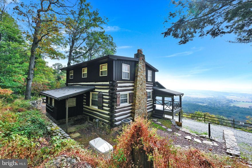 Public Auction Nov 17 2023, 2PM - Open Houses Saturday, October 28 1-3 PM and Saturday, Nov 4th 1-3 PM * Successful bidder required a 10% non refundable deposit - Settlement within 45 days - Buyer pays the 2% real estate transfer tax - List price does not reflect final sales price. A Mountaintop Experience! This captivating, tastefully remodeled 3Bed 2Full Bath "getaway" sits on 9.4 acres high atop the Blue Mountain; delivering truly breathtaking southern views of the farmland tapestry below! With its neatly crafted log charm and appealing classic upper/lower porches offering unmatched views, this home affords a tranquil enjoyment of the mountain breezes and panoramic sky that will chase away the cares of the world below. Inside you'll find a totally furnished home selling with all its furniture that presents a wonderful blend of primitive and modern style in the fully renovated array of timeless exposed log and stone walls, open beams, delightful tongue and groove ceilings, massive mountain stone FP with insert, pristine stone countertops, stainless appliances, oversized farmers sink, owners suite with soaking tub and walk in shower and crisp ceramic plank floors all served up with the utmost care and in a tastefully understated palette of colors. With a fully finished walk-out lower level guest suite and hidden laundry, there are 3 floors of enjoyment and discovery in a home that can serve as a primary residence and vacation retreat with equal ease! New mechanicals like a the propane hot air furnace and central air and 22 KW generator with 1000 gallon propane tank will help the focus to be on enjoyment and exploring the natural setting and attractions like the Appalachian trail itself (only a short walk away) and other wider trails that run the ridge all the way to Hawk Mountain! Imagine experiencing all this enjoyment and serenity only minutes from major PA routes! Come share this powerful experience and make this special offering yours! Reserved items : WIFI hotspot and 2 security cameras.