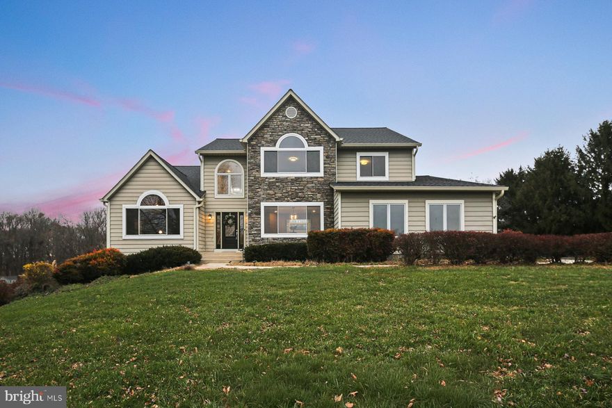 Welcome to 13880 Kennard Dr — Tucked away on 3.69 private acres in sought-after Western Howard County, this gorgeous and thoughtfully updated 4-bedroom, 3.5-bath home offers nearly 6,000 square feet of finished living space, an open-concept layout, and resort-inspired indoor and outdoor amenities—all in a peaceful country setting within access to top-rated schools.  A grand two-story foyer sets the tone, opening to light-filled living spaces enhanced by fresh paint, new carpet and flooring, and oversized windows that beautifully frame the surrounding landscape. The main level features an elegant formal dining room, a living room/flex space with a vaulted ceiling, and a spacious family room anchored by a wood-burning fireplace with a custom tile surround and dramatic soaring ceilings. The updated kitchen is ideal for both everyday living and entertaining, showcasing white cabinetry, granite countertops, a center island, and a convenient pantry.  The main-level primary suite is a true retreat, offering vaulted ceilings, an expansive sitting area, built-in features, two custom walk-in closets, and a refreshed en suite bath complete with a soaking tub, stall shower, and dual vanity. Upstairs, three generously sized bedrooms and a refreshed full bath provide comfortable accommodations for family or guests.  The finished lower level enhances the home’s versatility with a full bath, an office/bonus room/potential bedroom, extensive storage, a fitness room with wet bar, and a large kitchen and family room area—making it ideal for multigenerational living, extended guest stays, or hosting unforgettable gatherings, including pool parties and holiday celebrations.  Outdoor living is exceptional, offering a large deck, in-ground pool, turf field, and serene views—creating your own private oasis for relaxation, recreation, and entertaining. A two-car side-loading garage completes this remarkable property.  Enjoy unmatched privacy, generous space, top-tier schools, and timeless country charm, all while remaining just minutes from major commuter routes. This is Western Howard County living at its finest. Schedule your private tour today.