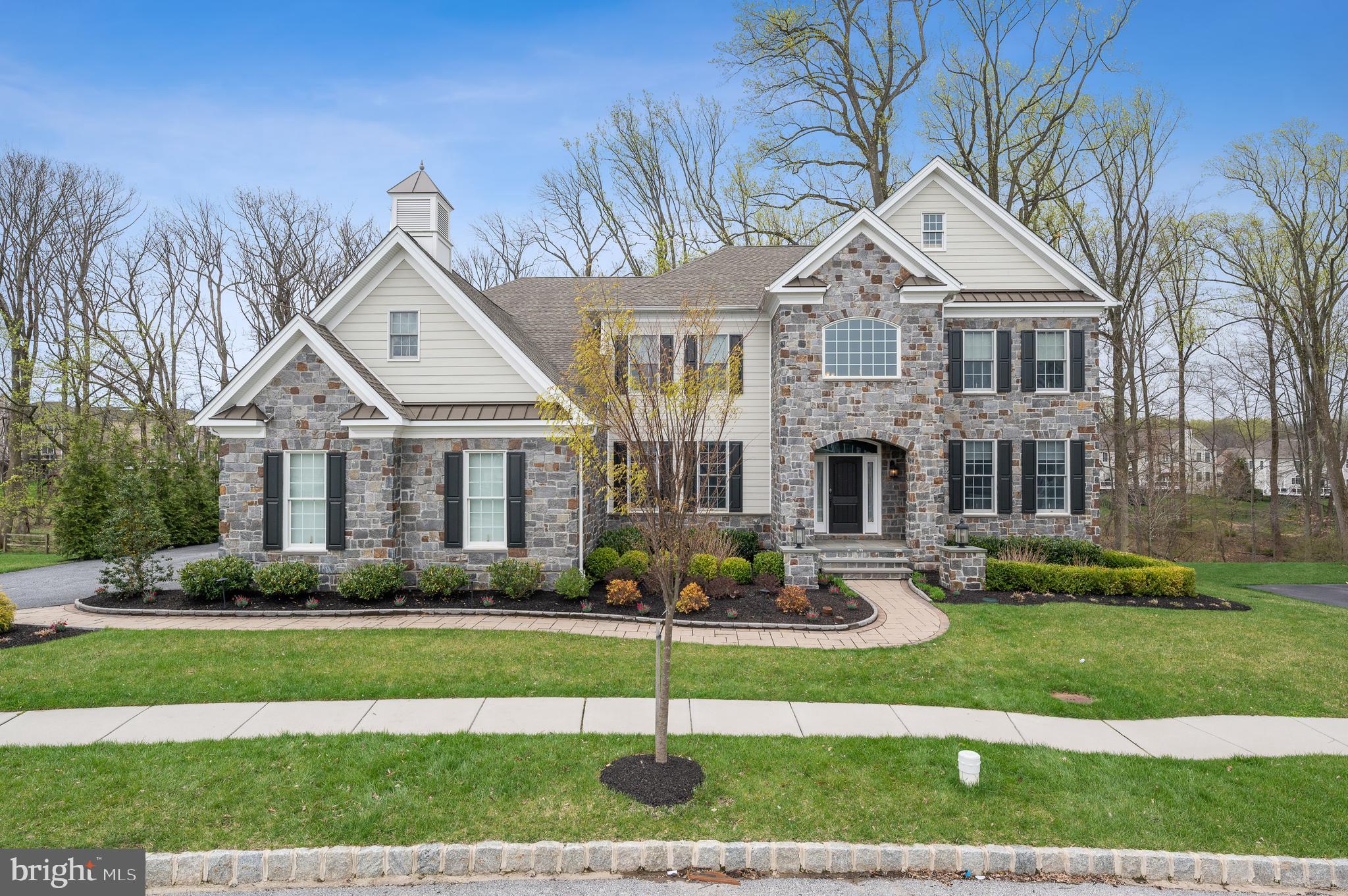 Welcome to this truly magnificent 4 bedroom, 4.2 bathroom home situated on a quiet cul-de-sac street in the coveted development of Liseter and within top rated Marple Newtown School District! From the open floor plan to the beautiful architectural accents and numerous upgrades, every detail of this home makes it a must-see! Thoughtful additions such as decorative moldings, wainscotting, recessed lighting, and tray ceilings abound in this move-in ready home. Enter the dramatic two-story foyer and you are greeted by gleaming hardwood floors, formal living room, formal dining room with adjacent butlers’ pantry, and grand twin staircases framing a view of the comfortable and spacious great room with stone façade fireplace and mantle. The heart of this spectacular home is the chef-inspired kitchen, open to the great room and featuring a massive center island, stainless steel appliances, 6 burner cooktop, granite countertops, large pantry, kitchen command center, and generous breakfast area with sliding glass doors granting access to the large screened porch with gas fireplace and inviting maintenance free deck- perfect for indoor/outdoor entertaining and dining! Rounding out the main level is a cozy study with a fireplace and built-in window bench; a powder room; and adjacent to the kitchen is a large mudroom with bench and storage cubbies plus interior access to the large three car garage. Upstairs, the impressive primary suite offers an elevated three-sided designer fireplace, coffered ceiling, separate sitting area with coffee/beverage bar, a large walk-in closet, and a luxurious spa-inspired bath with 6 foot whirlpool soaking tub, expanded shower with multiple jets, rain head, and Kohler DTV digital shower system, heated flooring, dual vanities, plus an additional expansive walk-in closet/dressing room. Also on the second level are 3 additional generously sized bedrooms –each with attached designer bathrooms and walk-in closets with custom storage. Conveniently located amongst the second level bedrooms is the large laundry room with cabinet storage, a sink and full-sized washer and dryer. The finished daylight lower level is not to be missed- offering a built-in bar with sink, beverage fridge and ice maker, a half bath, and plenty of open space for gaming, gym equipment, watching tv, or hanging out. There is also a very large storage area with custom painted floor that could easily be finished for extra living space! Upgrades and extras such as expanded three car garage, whole house generator, smart home security system, custom closet organization, automated window treatments, and exterior lighting and landscaping are sure to impress! The development of Liseter is central to everything – all major roadways for an easy commute to Philadelphia and Wilmington, just a short drive to Paoli Train Station with stops to NYC: less than a mile to SAP, Ellis Preserve and the prestigious Episcopal Academy; and minutes to downtown Wayne and Devon with an array of amazing dining and shopping options. Liseter offers a community pool, tennis court, fitness center, and beautiful club house. Make your appointment today to see this stunning property– it will not disappoint!