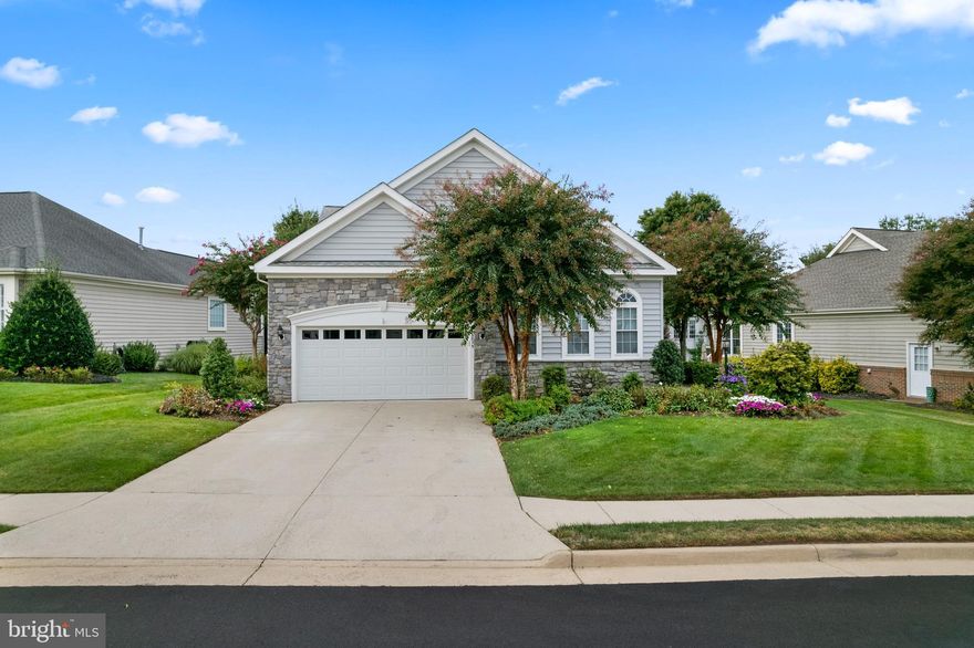 Welcome home! You spoke, and we listened. We’re back on the market after significant upgrades to the flooring and paint.
Nestled in the prestigious Heritage Hunt Golf & Country Club—a vibrant 55+ active adult community—this stunning Yardley model home combines sophisticated living with resort-style amenities. Enjoy golf, pickleball, bocce, tennis, walking trails, and more in this dynamic neighborhood. The striking stone-and-vinyl-siding exterior, unique side entrance, and expansive Trex deck with screened-in area create the ideal setting for relaxation or entertaining.
Inside, the main level dazzles with gleaming hardwood floors, premium carpeting, fresh neutral paint, and crisp white trim. Architectural details—crown molding, chair rail, and floor-to-ceiling columns—elevate the sun-filled living room. The formal dining room, illuminated by a chic chandelier, flows effortlessly into the gourmet kitchen, which features a center island, Corian countertops, stainless steel appliances, and a cozy breakfast nook. The airy family room, with its vaulted ceilings, ceiling fan, and generous wall space, opens directly to the oversized deck and beautifully landscaped backyard complete with an in-ground irrigation system—a perfect spot for quiet outdoor gatherings.
The serene primary suite offers a spacious walk-in closet and a luxurious en-suite bathroom with double vanity and newly renovated tile shower. Two additional bedrooms and a full hall bathroom provide plenty of room for guests. The newly carpeted lower level is an entertainer’s dream, boasting a large recreation room, legal fourth bedroom, third full bathroom, and a sizable utility room with updated water heater, abundant storage, and walk-out access to the rear yard.
Heritage Hunt’s exceptional amenities—including a clubhouse with restaurant and bar, indoor and outdoor pools, pickleball, bocce, and tennis courts—are just a short stroll away. Conveniently located near major commuting routes and Virginia Gateway Center for shopping and dining, this impeccably maintained home delivers the perfect blend of elegance, comfort, and active lifestyle. Schedule your visit today!