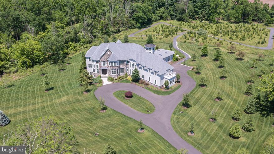 Opulence personified in Upper Makefield Township on over 12 acres in an upscale reserve. Exquisite Zaveta built estate home with one-of-a-kind amenities that include an amazing indoor pool with hot tub, slide and access to a full bath. Enjoy pool parties all year round! The 3rd floor observatory offers 360-degree views for the stargazing enthusiast and catching all of the celestial events. Take a relaxing stroll along your own private quarter mile trail conveniently located right out the back door with specimen plantings that give the illusion of a tranquil meadow and includes over 2000 daffodils/narcissus on the trail and 4000 on the entire property. Custom built only 6 years ago with stunning maple floors, brilliant light fixtures,10’ ceilings, spacious Gourmet Kitchen to include 2 islands, 4 ovens, 2 cooktops, ice maker, deep fryer, pot filler, two huge walk-in pantries and an in-house sound system. Over 11,000 sqft of incredible, finished space, this 5 Bedroom, 6 Full Bath, 2 Half Bath estate includes fantastic wine storage and butler’s area ideal for wine tasting, multiple studies to work peacefully at home, wonderful outdoor retreats including private balconies, a finished Lower Level with 10’ ceilings and includes a significant craft room with Quartz counters, 800 bottle wine room, security cameras with panic room, game room and a whole house 50 KW generator.  The incredible attention to detail and incomparable rural setting feels worlds away yet less than 4 miles into the heart of Newtown’s shopping and dining, less than 9 miles to the I-295 corridor for commuting to NYC and Philadelphia and just over a mile to the award-winning Sol Feinstone Elementary in the Council Rock School District.