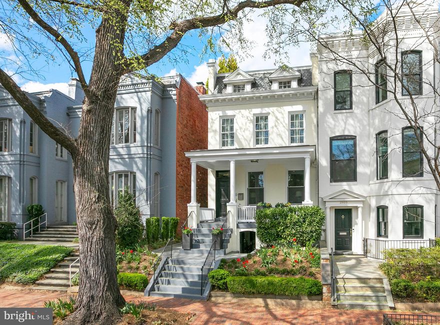 Fully renovated, semi-detached townhouse in the heart of Georgetown with abundant natural light and high ceilings throughout. Boasting a particularly wide lot and garden, and fabulous front porch, this elegant 4 BR/3.5 BA home offers sophisticated city living both indoors and out. Fully finished lower level with front and rear egress.

Entry into the combined living and dining space provides a warm and spacious welcome. The main level also includes a chef's kitchen with marble countertops and island and new stainless steel appliances. The adjacent family space accesses the rear of the property via French doors. Pantry storage and a powder room complete the main level. Outdoors, the private terrace provides generous dining and relaxation space, a gas line hookup, mature landscaping and street access via private, gated alley.

Upstairs the primary suite enjoys garden views, a large walk in closet and fully renovated marble bath. Two additional bedroom suites AND a dedicated home office complete the upper level. The lower level with full ceiling heights, front and rear walkout, provides additional family room space with wet bar, indoor and outdoor storage, bedroom (or gym space), full bath and laundry.