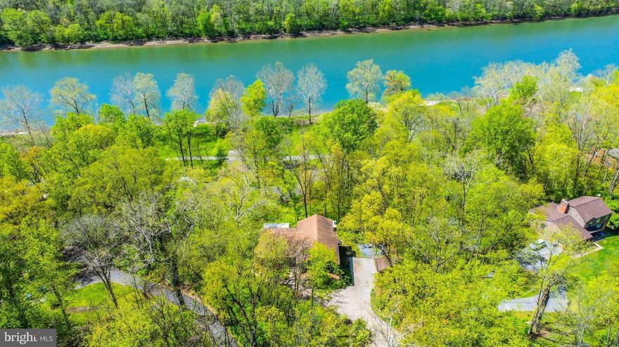 Welcome to your dream home located in the desirable Honeywood community, just steps away from the Potomac River. This residence is situated on over 1.11 acres of private woods and includes deep Potomac River access. Featuring 4 bedrooms, 3 bathrooms, and over 3,800 finished square feet, it also offers a finished basement with a kitchenette for added convenience. Vaulted ceilings, an elegant stone fireplace, granite countertops in the kitchen, and hardwood flooring throughout add to the home's charm.
Step onto the massive back deck, perfect for entertaining or simply relaxing while taking in the serene river views. With deep Potomac River access, residents can enjoy a variety of water activities such as boating, fishing, kayaking, and more. Take advantage of the community's amenities including a swimming pool, tennis court, and basketball courts, enhancing your lifestyle with both river access and modern comforts. Schedule your private tour today and discover the perfect blend of tranquility and convenience that this home offers.