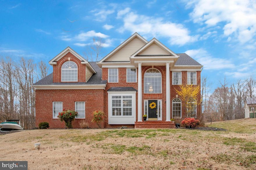 ** Big price improvement! ** Sellers are also  offering $15,000 in CLOSING HELP with a full-price offer! **  This stunning, updated, move-in-ready home in the sought-after Queensberry neighborhood sits on  a quiet cul-de-sac,  on nearly an acre backing to picturesque woods and open space. * A NEW ARCHITECTURAL SHINGLE ROOF adds to its appeal.  * The gracious TWO-STORY FOYER with gleaming HARDWOOD  floors and a dramatic balcony sets the stage for a spacious, light-filled interior. * The soaring TWO-STORY FAMILY ROOM with a cozy FIREPLACE flows into the OPEN-CONCEPT gourmet kitchen featuring ample white cabinetry, light granite, an island, and NEW STAINLESS-STEEL APPLIANCES, including two dishwashers!  * An extra-large formal dining room, elegant living room with a SECOND FIREPLACE, and a sizable FIRST-FLOOR OFFICE OR BEDROOM  provide exceptional flexibility. *  The first-floor laundry room, with a convenient chute, is located just off the kitchen and attached garage. ** 
Upstairs, the HUGE, LUXURIOUS PRIMARY SUITE offers vaulted ceilings, two walk-in closets, and a spa-inspired bath with a soaking tub, separate shower, and dual vanities. A cozy SITTING ALCOVE leads to an adjacent room perfect as an office, lounge, nursery, or easily converted back into a fourth bedroom.  * Two additional large bedrooms share a beautifully UPDATED HALL BATH.  ** The FINISHED WALK-OUT BASEMENT is bright and spacious, featuring a large recreation room, oversized full bath, and a versatile bonus room with a walk-in closet, currently used as a bedroom—ideal for guests or extra living space. Already prepped for a bar, kitchenette sink, or additional laundry, the basement is perfect for an IN-LAW SUITE.  ** 
Step outside to a private backyard oasis with a FENCED-IN AREA, elevated DECK with a charming trellis, patio, and a new oversized HOT TUB, making it the perfect entertaining space. The expansive level lawn offers plenty of room for sports and outdoor fun. **  Enjoy the peaceful Calvert County lifestyle, with its sought after schools,  and proximity to the many WATER-ORIENTED ATTRACTIONS of North Beach,  Chesapeake Beach, and various county parks on the Bay and River.  Just a SHORT DRIVE TO THE STORES, restaurants, hospital and commercial center in Prince Frederick.   Enjoy an easy commute to DC , Andrews AFB or Annapolis. Schedule your private tour today! **  
Recent upgrades include: a new roof (2023), second-floor heat pump (2023), high-efficiency hot water heater with recirculation system (2023), water softener (2023), well pump (2024), stainless steel appliances (2023), oversized hot tub (2023), light-colored granite countertops (2023), water-saving toilets (2023), freshly painted interior (2023), updated light fixtures (2023), and kitchen and bath cabinets painted with new hardware (2024).