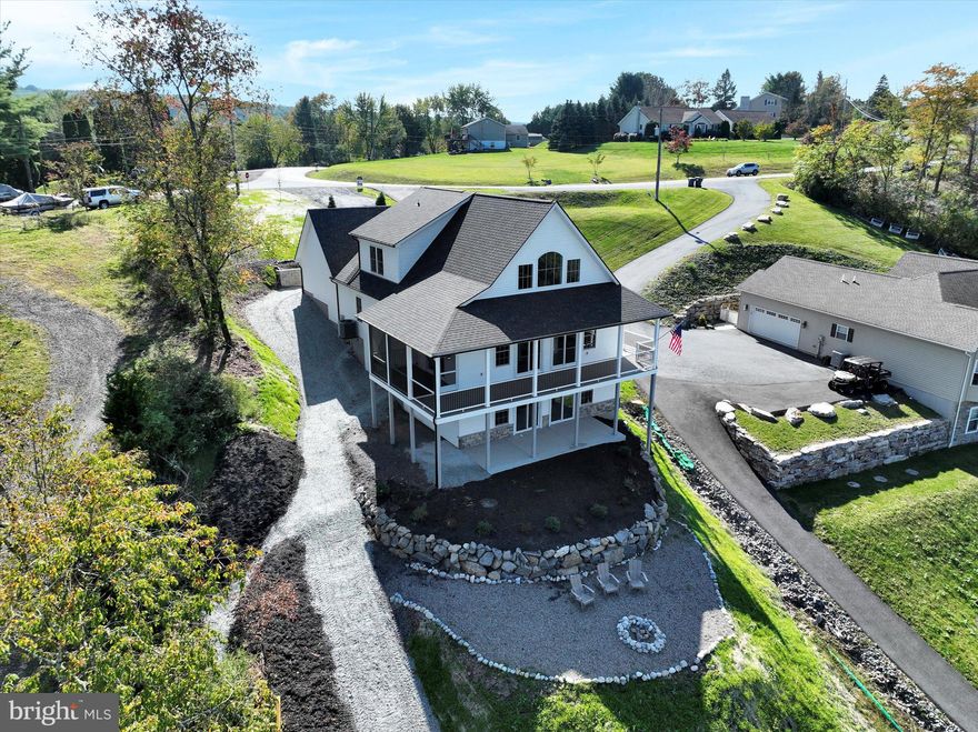 Position yourself for the future. Seeking far-sighted and visionary buyers during dam rehabilitation project for this custom 4BR/3.5BA newer construction chalet by Mas-Tek Builders. A rare find in Lake Wynonah! This gorgeous home perfectly nestled in Pinto Cove offers new buyers the finest upgrades and a fantastic floor plan. The open concept main level encompasses a vaulted great room with cathedral ceilings, and a stunning gas fireplace with stone chimney. A fully appointed kitchen with solid wood Faircrest cabinets, dovetail drawers, beautiful, white quartz countertops, oversized island with wet sink and Café appliances invites family and guests to enjoy fellowship and meals together. Primary bedroom with large walk-in closet and en-suite plus adjoining laundry. An additional guest bathroom and foyer complete the main floor. The second floor includes two spacious bedrooms and a full bathroom with loft views of the cathedral ceiling and landscape. Lower level features a wet bar with a beverage cooler, expansive space for entertaining and an additional large bedroom, full bathroom, utility and storage area. At full pool, this property offers a private dock site, 12X20' paver patio and floating dock, boasting phenomenal views spanning to the dam breast. Water and electricity provided by the patio area. Prominent views of nature can truly be enjoyed from many rooms, and birdsong offers a natural, soft fascination enjoyed from the wrap-around deck, screened in porch and below-deck patio area. Paved driveway with turnaround loop and plenty of extra parking at top of property. Two-car attached, oversized garage. Structural and cosmetic details include: solid core interior 2 panel arch top with V groove doors, fiberglass 1/0 x 3/0 x 1/0 front entry door unit with Deco craftsman glass, Quoizel lighting, Bruce 5’’ hand-scraped engineered prefinished flooring (first floor other than bathroom and laundry room), lower level is 6.5 mm 22mil wear layer rigid core flooring, MI vinyl windows, composite decking. Homeowners have completed the following improvements since purchase in 2024: patio repour, path to waterfront area improved/water redirected, regrading with new stone, *added turnaround area at waterfront, re-built dock, patio rock wall re-done and added Moen Flow WIFI water valve shut-off. *About 10 feet of the turnaround area falls onto the neighboring property, but pathway is entirely navigable without the turnaround. Neighbor has been agreeable to allowing turnaround, which allows for ease of access. HOA amenities include: business office/gathering room/library, lodge w/dining and bar, social clubs, electric/trolling motor boating, fishing, tubing, paddleboarding, tennis, pickleball, several parks/pavilion, basketball courts, horseshoe pits, pool, beautiful docks, hiking, natural wildlife and marina. Groups and events can include: Active Civic Association, Dances/Concerts, Book Group, Pinochle Group, Volunteer Programs, Fish & Boat Group. Located less than an hour from Allentown, Harrisburg, Hershey and Reading. Lake Wynonah offers a distinctive, natural setting close to the Appalachian Trail, Schuylkill River Greenways/Schuylkill River Trail, locally owned restaurants, newer hospital, shopping and quaint towns. Buyers are encouraged to due diligence, yet explore potential - please call the Lake Wynonah Business Office for updates regarding the Lake Wynonah Dam. Boating is restricted to electric/trolling motors, kayaks/paddleboards/canoes/row boats only while the Lake Wynonah Dam is being rehabilitated. Lake Wynonah continues to be drawn down per DEP.  Fawn Lake is separate from Lake Wynonah. The Fawn Lake Dam was repaired in 2009. Some photography displays Lake Wynonah at full pool. Please call the Lake Wynonah Business Office for updates on the "big lake"/Lake Wynonah Dam rehabilitation project/DEP Consent Order and Agreement, and probable future assessment. Taxes are estimated.