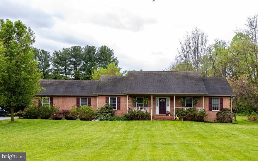 Welcome to this beautiful brick-front rancher offering comfortable one-level living in a serene rural setting. A large front porch invites you to sit back, relax, and take in the peaceful landscape before stepping inside.

The spacious open living area features gleaming hardwood floors, a cozy gas fireplace, and an elegant tray ceiling. The kitchen is a cook’s delight with stainless steel appliances, a brand-new refrigerator, wood cabinetry, and a convenient island perfect for meal prep and gatherings. The adjoining dining area comfortably accommodates a large table and china cabinet, with a bay window and door leading to the rear deck—ideal for grilling and enjoying outdoor living.

A thoughtfully designed hallway separates the living spaces from the private bedroom wing. You'll appreciate the convenience of a separate laundry room. The primary suite offers a tray ceiling, ceiling fan, plush carpeting, and a generous dressing area with multiple closets, leading to a private full bath with a 4-foot walk-in shower.

Two additional bedrooms provide ample space for guests, a home office, or playroom, each equipped with large closets. The hall bath features a tub/shower combination and single vanity.

Situated on .83 acres, the expansive lawn and fenced garden area create a perfect retreat for growing vegetables, flowers, or simply unwinding at the end of the day. Despite the peaceful country feel, you’re just minutes from I-81 (Exit 12) and close to shopping, dining, and more.

Don’t miss the opportunity to call this charming property your next home!