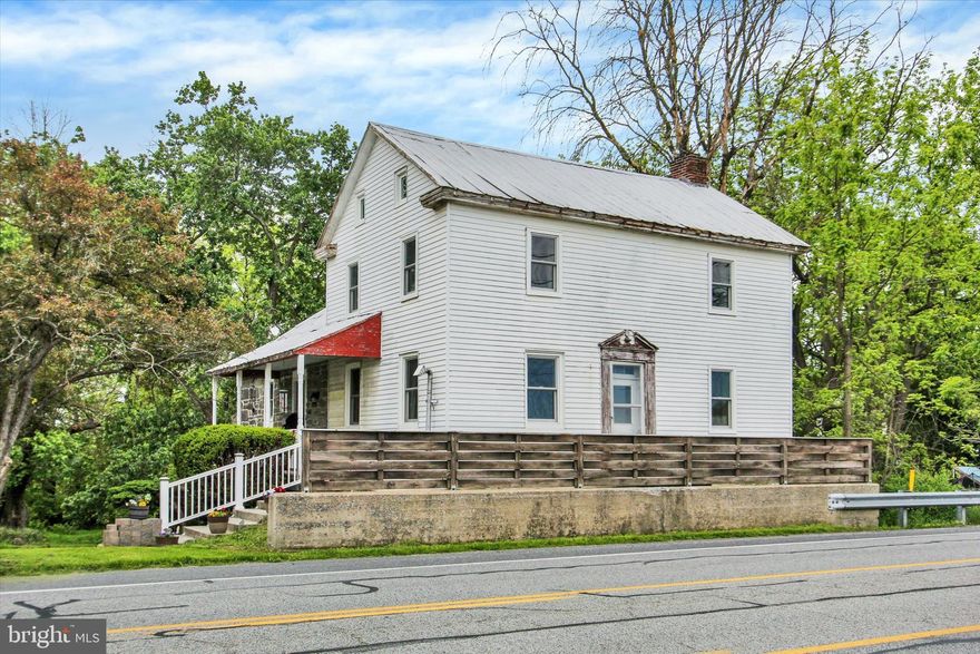 Step into history with this charming 3-bedroom home originally built in 1860, blending timeless character with thoughtful modern updates on a picturesque 1.7-acre property. Perfectly positioned near Historic Downtown Gettysburg and the Battle of Gettysburg battlefield area, this unique property offers convenient access to museums, tours, dining, entertainment, and family activities while still providing peaceful country charm.


The kitchen beautifully preserves the home's historic character with its original fireplace while incorporating modern updates including new cabinetry, newer appliances, a wine refrigerator, and a new built-in microwave. The home also features a newly installed Jacuzzi walk-in shower, remodeled second-floor primary bedroom, new flooring in the main-level bedroom and laundry room, and 19 brand new Renewal by Andersen windows. A Culligan water softener system adds additional comfort and convenience.


Outdoor features make this property truly special. Enjoy a scenic creek running near the edge of the property, mature Sugar Maple and Black Walnut trees, fruit trees including peach and apple, and a vegetable garden with terraced beds enclosed by deer-proof fencing and gate access. A balcony off the kitchen overlooks the property and features illuminated stairs leading down to the yard, creating a peaceful outdoor retreat.


Additional features include an outside dog kennel near the pole garage and flexible zoning that allows both residential and commercial use. With excellent visibility and high traffic exposure, this property presents an exceptional live-work opportunity ideal for a home office, beauty salon, boutique business, studio space, and more. This one-of-a-kind property offers the perfect blend of historic charm, modern functionality, and entrepreneurial potential.
