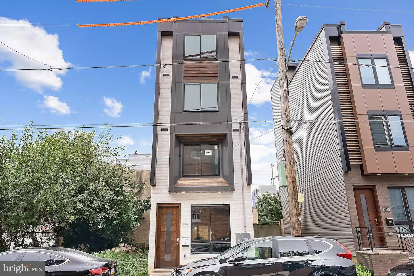 Welcome to this stunning custom-built newer construction home located in the heart of the Grays Ferry section of Philadelphia. This thoughtfully designed four-story residence offers an exceptional blend of modern luxury and functionality. Step into a bright and spacious living room that seamlessly flows into the dining area and a beautifully appointed contemporary kitchen—perfect for both entertaining and everyday living. Just off the kitchen, you'll find access to a cosy, and private rear patio. The mezzanine level features a secondary living area or den. Upstairs, two generously sized bedrooms and a full bathrooms offer comfortable living quarters. The top-level is home to the private primary suite, complete with a custom walk-in closet and a spa-inspired bathroom featuring a soaking tub and elegant finishes. Just a few steps more, you will have access to your private rooftop. Take in breathtaking views of the Philadelphia skyline from your rooftop deck, which includes a built-in hot tub and ample space for relaxing or hosting guests. The fully finished basement provides additional flexible space, including a potential fourth bedroom, office, gym, or media room, along with a full bathroom, and utility room. Property also has Tax Abatement. This home is ideally situated close to the UPenn, major highways, public transportation, the airport, shopping, and some of the best that Philadelphia has to offer. Don’t miss this opportunity—schedule your private tour today!