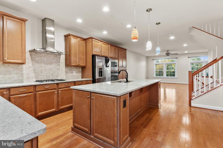 Modern 3-level brick-front townhome in the sought-after Discovery Square community. Features three bedrooms, 3.5 baths, a lower-level office or guest space, and a 2-car garage. Enjoy a bright, open layout with hardwood floors, a gourmet kitchen featuring granite countertops, stainless steel appliances, and a spacious island. The family room opens onto a private balcony, while the primary suite features a walk-in closet and a spa-style bath. Conveniently located near Dulles Airport, Silver Line Metro, major routes, shopping, and dining. Perfect blend of comfort, style, and location.