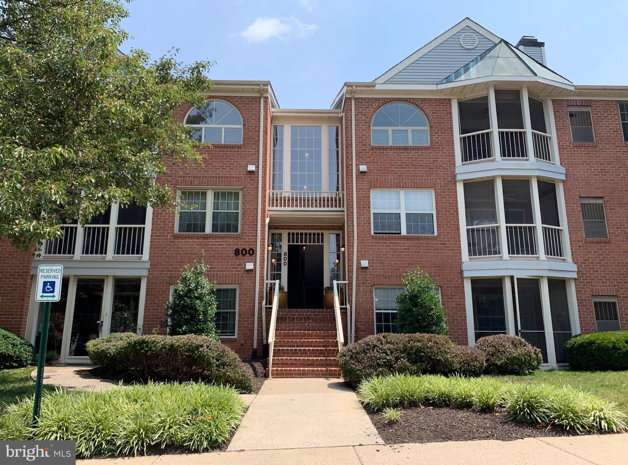 Spacious and Private Condo in The Oaks at Washingtonian Woods. Lovely ground level 2BD/2.5BA condo featuring hardwood floors, updated galley kitchen with granite countertops, lots of storage, separate dining room, beautiful archway, decorative fireplace, private enclosed patio with lush, green views, full size washer/dryer in separate laundry room. Two primary bedroom suites each with private bath and ample closet space. Neighborhood pool, walking paths, tennis courts, basketball court and a playground. Located close to major commuter routes, Rio/Downtown Crown, Kentlands and more!