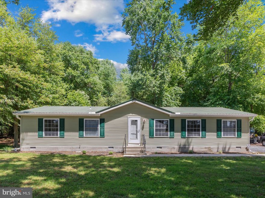 Very cute home located on a .87 acre wooded lot! Features an updated kitchen, vinyl flooring, updated baths, new gutters, metal roof, and newer windows. Theres's a large kitchen with an island and a large pantry for all your storage needs. Enter into the large living room area with dining area combo in the front of the home, with the kitchen in the rear. All bedrooms, living room and dining room have ceiling fans. The main bedroom bathroom offers a jetted tub. 25x17 rear deck looks out over the wooded back yard with shed. Lots of parking for guests in the wide driveway as well. Don't miss out, this surely won't last long!