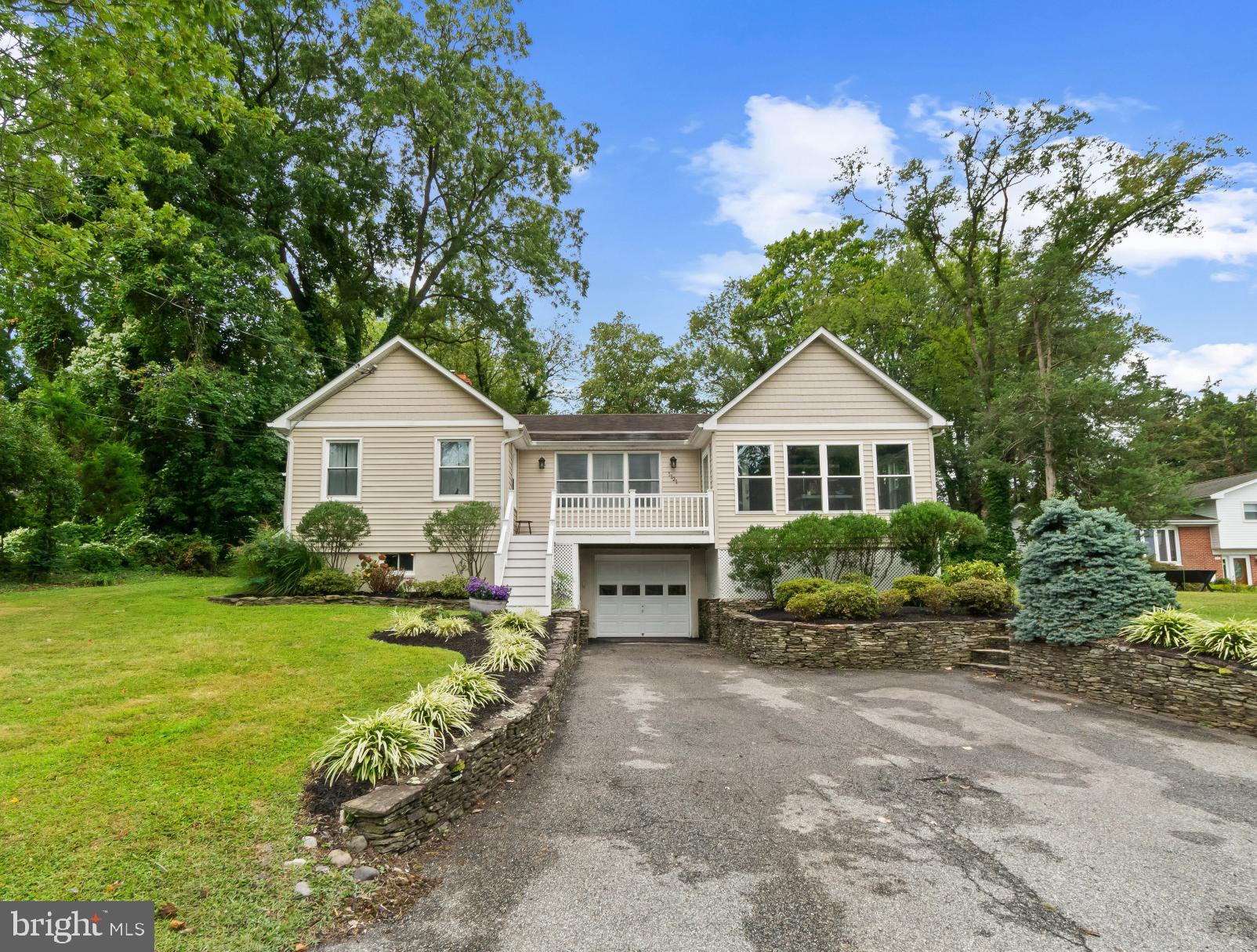Charming single-family home offering 1,658 square feet, 3 bedrooms, 2 full bathrooms, and a 1-car garage, perfectly situated in nautical Edgewater. From the moment you arrive, the home delights with gorgeous curb appeal featuring thoughtful landscaping, stone retaining walls, a spacious driveway, and an elevated front porch that sets a welcoming tone.
Step inside through the stained-glass accented entryway to find a charming interior filled with natural light and character. The sunlit living room showcases panoramic windows and rich jewel-toned green walls, while the adjoining dining room features a classic chair railing. A vaulted-ceiling family room with a striking stone-accented fireplace provides the perfect space for gathering. The bright eat-in kitchen is designed for both style and function, complete with a partial white subway tile backsplash, white cabinetry, stainless steel appliances, a peninsula breakfast bar with pendant lighting, and a cozy breakfast nook with sliding doors that open to the patio. Additionally, find 3 comfortable bedrooms and two full bathrooms, including a spacious suite with a private attached bath and dual closets. A convenient laundry room with built-in shelving and exterior access adds everyday practicality. The finished lower level extends the living space with a versatile recreation room featuring an exposed brick accent wall, ideal for a lounge or entertainment area, as well as a dedicated storage/utility room.
Outdoor living is equally impressive with a beautiful patio surrounded by mature trees, perfect for dining or relaxing. A stepping-stone path leads to the expansive backyard and side yard, providing ample space for play, gardening, or entertaining. Enjoy the home’s ideal location with close proximity to Turkey Point Island Beach 3 access, offering waterfront recreation and natural beauty.
Water Heater replaced 2024 & HVAC replaced 2023!