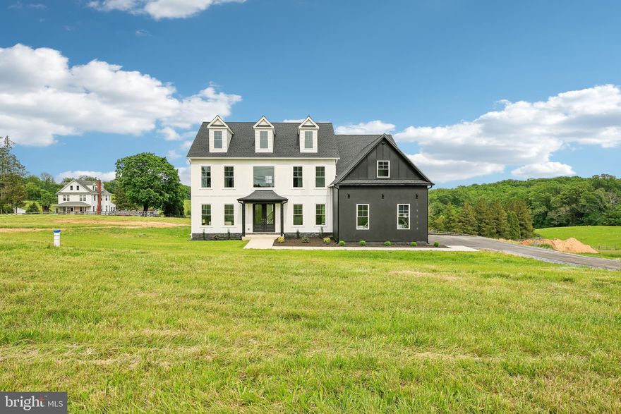 Welcome to 13719 Jarrettsville Pike, a stunning, completely move in ready, custom-built home that embodies the perfect blend of sophistication, comfort, and privacy. While construction is complete and the home can be delivered in 30 days, the list price includes $35,000 incentives and builder options! This brand new 6-bedroom, 5-bathroom residence offers over 5,000 square feet of thoughtfully designed living space, set on more than an acre of pristine outdoor grounds. Far off the road, you'll drive down the new asphalt driveway to the three car garage, with a black and white epoxy flooring. From the front door you and your guests will be welcomed by a 2 story foyer with a striking black iron and wood staircase, real hardwood flooring, and contemporary chandelier. The formal living and dining rooms help set the tone for the open concept layout, as you approach the centerpiece of the home, the two story great room. The contemporary design of this custom home is epitomized by the textured white tile surrounding the gas fireplace. The room is perfect for daily use and ideal for large gatherings as it flows right into the kitchen. A chef's dream, the kitchen  features a waterfall island, which seats four, a 5 foot long workstation sink (which allows for attachments, such as a cutting board, drying rack, cullender, and many more options) with two faucets. Abundant storage can be found in the wood cabinets, with under cabinet lighting, and even more prep space on the quartz countertops, while the mirrored backsplash adds to the contemporary design and feeling of added space. The walk in pantry means you’ll be able to keep your kitchen organized and you’ll never run out of storage. The main level bathroom has two doors, one that can easily be accessed off the great room or from the main floor bedroom, which could also be used as an office space. Once upstairs, you’ll marvel at the size, storage, and design of the primary bedroom suite. A California King bed will easily fit and still afford space for not just a sitting room, but an owner’s living room. The en-suite bathroom features an impressive glass enclosed shower, separate soaking tub placed under a large picture window with picturesque views of the pastures below, a double sink vanity, a water closet, and a dual walk in closet. Down the hall from the primary bedroom you’ll find two generously sized bedrooms with a jack and jill bathroom, with a double sink vanity. The fourth bedroom is another primary bedroom with its own en-suite bathroom. The walk-out, finished basement offers even more flexibility, with a family room, bedroom, full bathroom, and a flex space that could be a gym or theater room, as well as unfinished space for storage. With over an acre, the yard can be customized to your desire, with room for a large deck, pool, hardscaping, and still plenty of green grass space for playing and gardening. This construction has been completed and be delivered in under 30 days! However, builder options for your deck design, patio, and custom closets are available with a $25,000 credit. An additional $10,000 is available towards your closing costs or to lower your interest rate. Schedule your tour today!