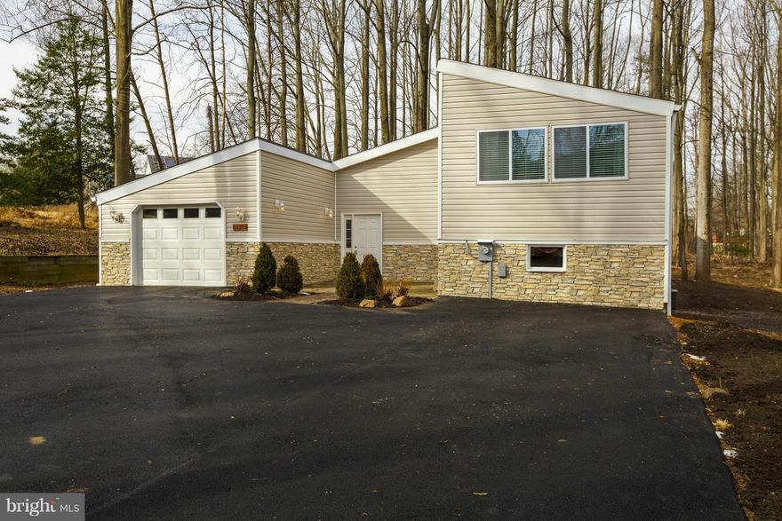 Spacious, inviting, and unique home nestled on a 1+ acre wooded wonderland.  Full renovation in 2016 includes open floor plan, w2w hdwd, new ss appliances, designer cabinets, quartz ctrtops, master suite with roman tub, gorgeous tile work throughout, wooden blinds, custom drapes, new siding, new roof, new ac system, new driveway.  Minutes away from the ICC, Metro station, shopping, and dining.