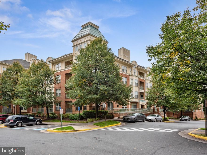 Stunning home in Reston Town Center! Welcome to this 2 Bedroom, 2 Bath Condo  with a large open kitchen with Brand new Stainless Steel appliances and pass through opening to view the living and dining area.    The large windows, gas fireplace, decorative moldings, luxury vinyl flooring and ample spaced balcony awards a perfect space for entertaining.  The two bedrooms on either side of  the home provide a separation for added privacy.  The primary bedroom offers an en suite bath with decorative Italian imported ceramic tile with two large closets.  The second large bedroom is adjacent to the full guest bathroom and offers plenty of closet space.    The home has its own dedicated garage parking space and storage unit.   The community amenities are sure to please and to include, clubhouse, pool, fitness center, and business center.  Jump on the trail and be just a short bike ride or walk to the Wiehle METRO stop. Welcome Home!