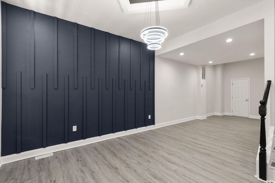 Fully renovated and thoughtfully redesigned, this spacious 4-bedroom, 2.5-bath Baltimore City home offers four finished levels of modern living with flexible spaces throughout. Featuring an open-concept layout, contemporary finishes, and abundant natural light, this home delivers the perfect blend of style and functionality.

The main level welcomes you with wide-plank flooring, recessed lighting, and a striking custom accent wall that creates a warm, upscale feel. The beautifully updated kitchen features white shaker cabinetry, stainless steel appliances, modern fixtures, marble-style flooring, and breakfast bar seating ideal for entertaining and everyday living.

The upper levels provide exceptional versatility with den/flex spaces on both floors—perfect for a home office, sitting area, playroom, fitness space, or guest setup. The spacious primary suite includes a walk-in closet and modern finishes throughout.

Additional highlights include updated bathrooms, dedicated laundry area, contemporary lighting, stylish black railings, and multiple levels of finished living space rarely found in the area.

Conveniently located near downtown Baltimore, major commuter routes, hospitals, universities, and local dining. Move-in ready and designed for modern city living. Schedule your showing today.