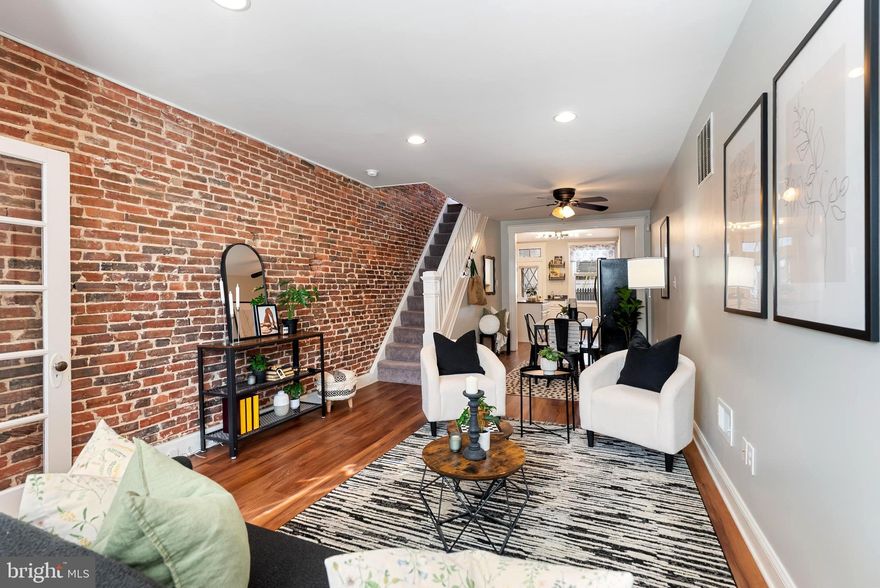 Beautiful 2 bedroom townhouse  just a few steps from Paterson Park and set on a distinctive block featuring white marble steps and classic brick front homes. The main level offers an open concept layout with a spacious living and dining area connected to a gourmet kitchen featuring granite countertops, stainless steel appliances and a kitchen island. The space flows out to a large fenced backyard patio perfect for entertaining or private outdoor relaxation Upstairs you will find two spacious bedrooms with big windows, two walk in closets along with a full bathroom featuring a bathtub. The finished basement provides excellent additional living space with the potential for a large recreation or family room and a separate room with laundry and ample storage. Additional features include, central air, exposed brick, walls recessed lighting, abundant natural light throughout, windows updated in 2020, LVP flooring installed in 2021 and water heater from 2021. Conveniently located near Johns Hopkins Hospital restaurants, grocery stores, Paterson Park and major commuter routes; this home won't last, schedule your private tour today!