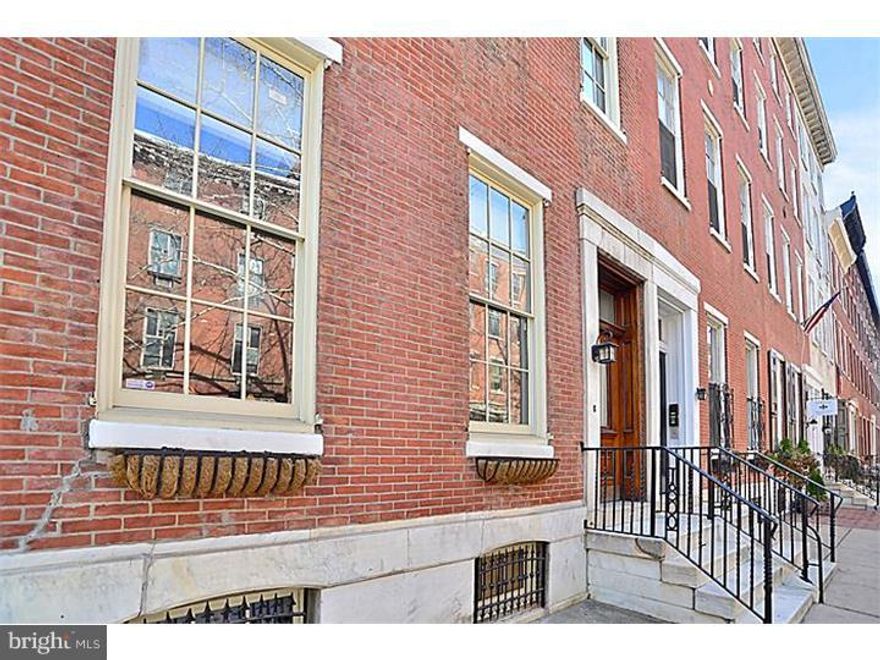 As you approach and enter this corner unit, which was originally a grand mansion building, now split into 3 multi-level condominiums, each with its own entrance, you will immediately notice how the historical features have been preserved.  As you set foot into the front door foyer area, you walk into a large, open floor plan living space with oversized windows, and high ceilings.  This particular unit was completely renovated with the finest custom finishes including custom scraped hardwood floors throughout and top of the line everything.  The kitchen has beautiful granite countertops, an over-sized sink, micro tile backsplash, & is equipped with Viking appliances, including refrigerator, range, microwave, and dishwasher.  The 2nd floor of this dramatic, custom condo, features 2 bedrooms and 2 full baths.  The master suite, which has a city skyline view, features custom closets and a large walk-in, ultra-luxury master bath with gorgeous white marble.  The basement is fully finished and features a bar dating to the room's reputed past as a 1920's-era gathering place.  The home had all new systems installed including all new electrical and mechanical, as well as all new plumbing.  8 years remaining on the tax abatement.  Conveniently located and within walking distance to 'everything' including beautiful Rittenhouse Square, many restaurants, dog parks, the brand new Schuylkill Banks Boardwalk, supermarkets, Penn, HUP, & CHOP, 30th train station, and much more!