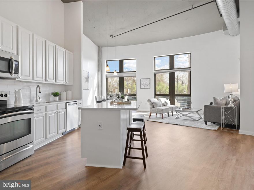 Stunning one bedroom condo, plus den in sought after Shirlington Village. This home has 15' ceilings with floor to ceiling windows in living and dining areas and the primary bedroom. The kitchen has been recently updated with white cabinetry, beautiful quartz counter tops and a new subway tile backsplash. The kitchen features an island with room for two stools and stainless steel appliances. The open and spacious dining and living rooms are yours to design, with tons of wall space for furniture or special pieces of artwork.
The primary suite has a large floor to ceiling window, walk in closet and attached primary bath. The bath has been recently remodeled with ceramic tile floors, a dual vanity, bath with custom tile surround and new designer lighting and mirrors. 
Just down the hallway from the kitchen is a room which can be used as an office, guest bedroom or den. It's a wonderful flex space. There is a second full bath, also recently remodeled with new vanity, ceramic tile floor, bath with custom tile surround and designer lighting and mirror. 
The condo comes with one garage parking space and a storage unit.
Located right in the heart of Shirlington Village you can walk to shops, restaurants, a Harris Teeter grocery store, the movies and a ton of outdoor recreational areas. 
Right off 395, you can be in DC in minutes. It's easy to catch a bus, or ride your bike to work. Don't miss out on this opportunity to live in an spectacular condo in a phenomenal area!