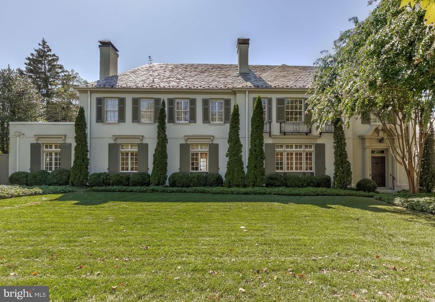 Welcome to this stately and stunning French Country home resting at the foot of the splendid Sherwood Gardens. A canopy of crepe myrtles ushers you to the grand entrance of this home blending 1920 s elegance with modern updates. Serene living spaces offer unique views suitable for every season. A classic vestibule leads to a sun-drenched, open staircase, grand living room, dining room & library all with wood-burning fireplaces. Hardwood floors, molding and soaring ceilings throughout. A white, eat-in kitchen with stainless steel appliances, soapstone counters, & breakfast bar. The kitchen leads to an office with entrance to garage, mudroom room, laundry room and rear staircase. Upper level has master bedroom with new spa-like bath, walk-in closet, wood-burning fireplace and french doors to second floor balcony overlooking rear gardens. One en-suite bedroom, 2 bedrooms with buddy bath and an additional bedroom, a large bonus room and full bath complete upper level.  The Lower level has new exercise room, sauna & full bath. The rear yard, accessible through french doors from every room, has elegant gardens, fountain, brick patios and paths all within the confines of a privacy wall. This home has undergone extensive improvements and updates. The Guilford neighborhood is convenient to many schools, universities and shopping with easy access to 83.