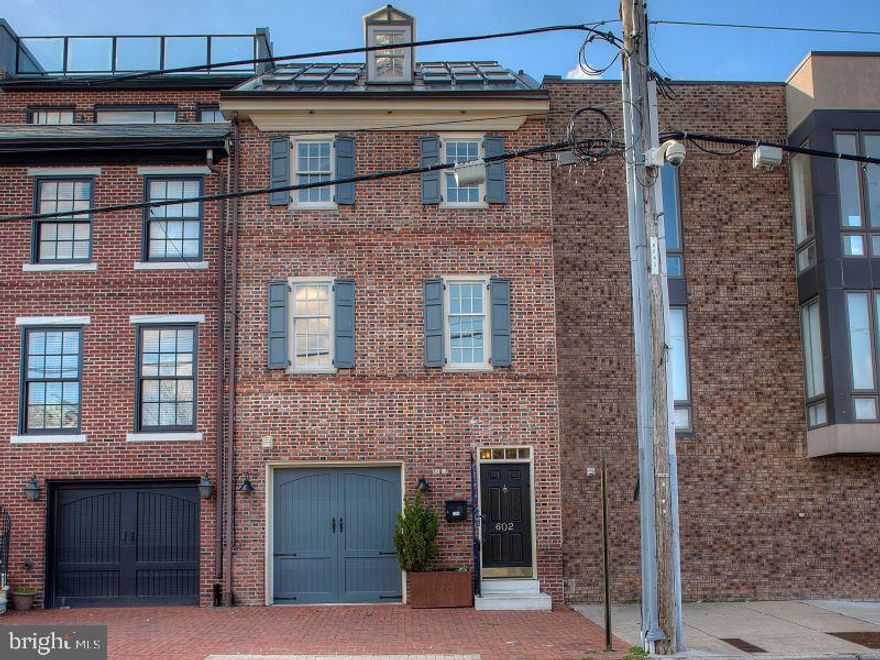 Welcome to 602 S Front located in the Queen Village neighborhood of Philadelphia and home to the blue-ribbon Meredith Elementary school. This turnkey home features 3 bedrooms, 3 1/2 baths, an oversized cook's country kitchen and garage parking. Located on a section of south front with unobstructed Delaware River water views providing for magnificent sunrises, gardens and grassy areas (that you don't have to mow) for kids and the dog and plenty of permit parking.  Within the near future you will have across the street access to Penn's Landing and a short walk to the "new park development" over I-95. This will be a game changer. This bricked front home started out as a trinity and was expanded over the years and was even featured back in 2005 on HGTV as a "good deal" in Philadelphia. The oversized entry features custom wainscotting that flows all the way into the dining room and kitchen, tiled floors, a large coat closet along with inside access to a 1 car garage with extra room for storage. Down the hall is the elevator that services all 4 floors and access to the basement which provides extra use for storage. The rear of the home features an enormous cook's country kitchen with 10' ceilings, wood beams and numerous skylights. This was designed by the current owner as her haven. The tiled floors are radiant heated for extra comfort.  The custom cabinetry in soft beige tones is completed by custom pewter pulls, Volga Blue Tropical granite, stainless steel appliances featuring Subzero, Thermador and Miele. A large island is fitted out with a farmhouse sink and plenty of workspace. Off to the side, there is a coffee station, an area perfect for a home office with storage and built-in desk. A custom China Cabinet with buffet completes the kitchen experience. All the cabinets have lighting that illuminate the interiors and work areas. The large dining room is adjacent. A bar area and powder room complete this level. This could also function as a large open concept living area with seating and dining. It's that big.
Moving along up the center staircase to the 2nd floor where you'll find an east facing living room with custom built- ins, hardwood floors and river views. The first bedroom suite is towards the rear and features a large, carpeted bedroom with an oversized walk-in closet and full ensuite bath with white tile and black stone accents. There is also a full laundry room with a custom unit for folding and a hanging area plus additional storage. The 3rd level features the primary suite with hardwood floors, built-in window benches with storage below and bookshelves, a sumptuous spa-like bath with his/her sinks and oversized shower featuring stone and glass accents. A large walk-in closet completes this space. Another carpeted bedroom with 2 large closets (one a walk-in) and full bath completes this level. The 4th floor features a vaulted ceiling, built-in bar area, sitting area and game room area. The finishing touch is a wall of windows giving you a full water view from the Walt Whitman bridge to the Ben Franklin bridge and a front seat for the fireworks. Off the rear is a spacious deck for relaxing and watching the sunsets.
This home was renovated with the finest finishes including speakers throughout, customized closets in every bedroom, pewter door handles, beautiful light fixtures and energy efficient recessed lighting. No detail was overlooked. A newer gas fired HVAC was recently installed as well.
Perfectly located and within walking distance to the year-round farmer's market at Headhouse Sq and to all of our city landmarks, waterfront activities including the new I-95 Park Cap which is scheduled to break ground in September and some of the best restaurants in the city.  And easy access to I-95 and 676.