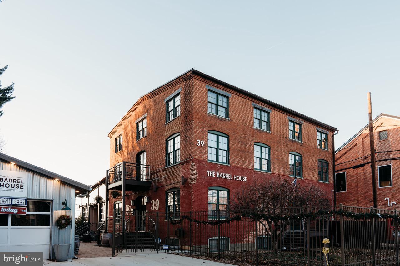THE BARREL HOUSE! Chambersburg's premier, "one of a kind" event venue is now looking for its next owner! This industrial modern venue is currently being utilized as a bed & breakfast, wedding and party venue, brewery and restaurant. The pictures speak for themselves! Lovingly restored with much of the rustic industrial architecture still intact, this property tells its own story as you walk through it.
The first floor contains a full-service commercial kitchen, hand-hewn bar and seating for guests. Adjacent to the kitchen is the upper terrace with seating for up to 120 guests. Adjust this area to suit the weather! Surrounded by industrial glass sliding doors, your guests will always have a view of the downtown urban landscape... whether you have them closed in the winter, or open to let in the summer air.
The second floor houses the primary suite, complete with a sitting room, office, sauna, kitchenette, laundry area, large bedroom and full luxury ensuite bath. There is also a balcony offering a view of the lower terrace.
The third floor contains 3 loft-style sleeping rooms and a full bath.
This is a unique offering of a very special property! Opportunities like this rarely present themselves. If you've been thinking of owning an event venue with unlimited potential, don't miss this chance!