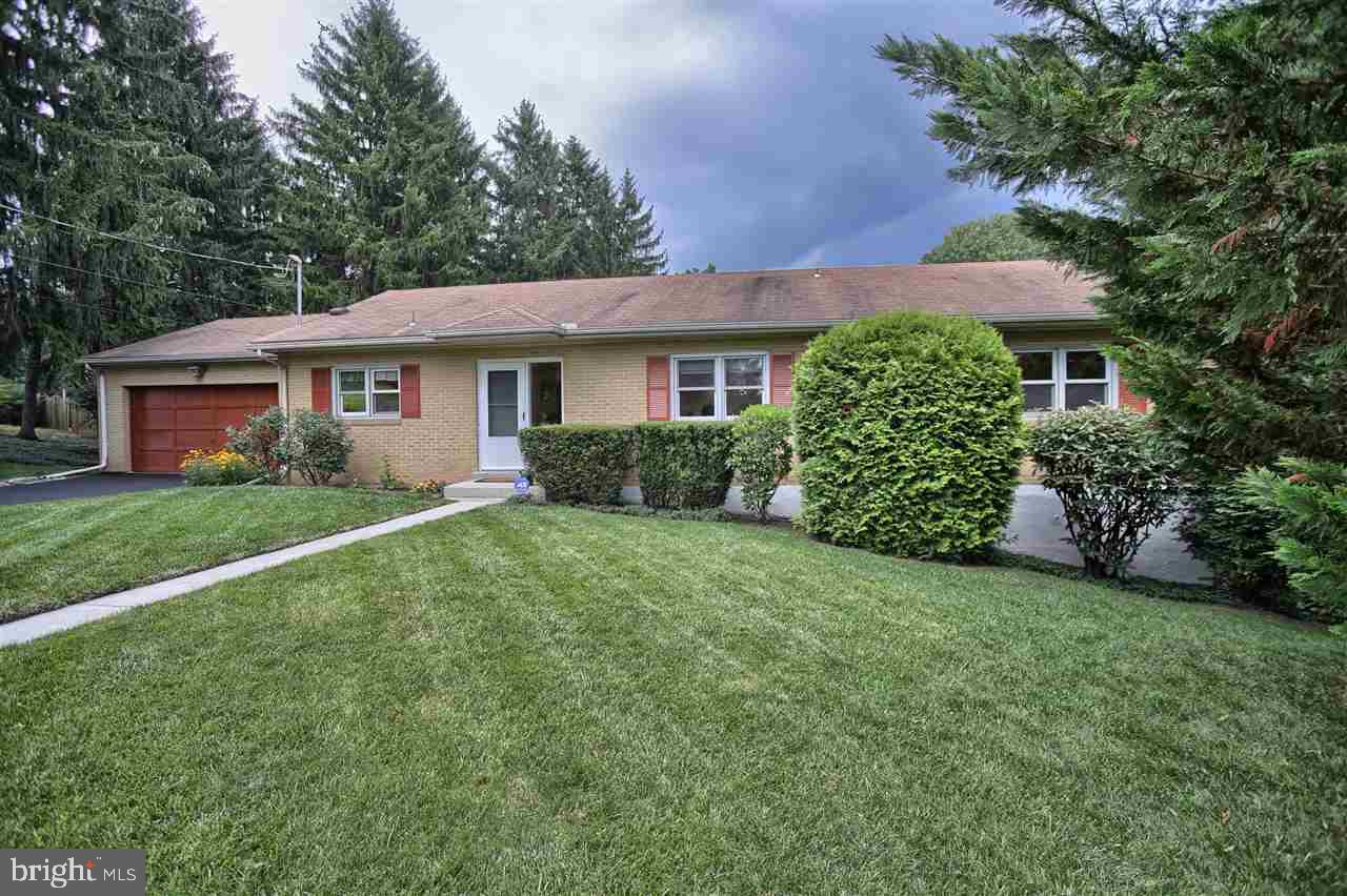 1 acre homesite w/tranquil wooded setting, trails, sweeping lawns & various gardens. 2600 sqft of living space in this solid brick ranch w/exposed walkout. Stately round-about driveway & 2 car garage. Spacious entry greats you into this beautiful home w/windows overlooking picturesque homesite. Gleaming hardwood flrs in FR, DR & bedrms. Eat-in kit w/double wall oven, tile flrs & pantry. Master suite w/private full bath. Finished exposed walk out w/abundance of storage. Great location to all of Central PA!