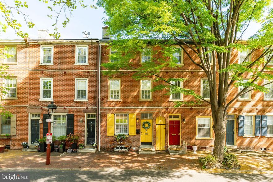 Welcome to this timeless and elegant 3-bedroom, 1 full and 2 half-bath historic townhome located in the heart of Society Hill.
This beautifully maintained residence offers a serene garden oasis, a second-floor deck, and a seamless blend of historic character with thoughtful modern updates.
Step inside the inviting main level, where a cozy living room features a wood-burning fireplace framed by custom built-in bookcases—perfect for quiet evenings at home. The updated kitchen boasts heated ceramic floors, a premium Fisher & Paykel range, Bosch dishwasher, and opens to a sunlit breakfast room. Bathed in natural light, this space includes sliding glass doors that lead directly to the lush rear and side gardens, creating a tranquil setting for your morning coffee or an evening glass of wine.

Upstairs, the second floor offers two generously sized bedrooms, including one with a private deck overlooking the beautifully landscaped garden. A spacious full bath and a well-appointed laundry room with Electrolux washer and dryer and ample storage complete this level.

The third-floor primary suite features a dramatic cathedral ceiling and a convenient half bath, offering a peaceful retreat above the city.

A clean, dry basement provides abundant storage, and the home is situated within the highly sought-after McCall School catchment. Directly across from Starr Garden Playground and just moments from Whole Foods, Acme, Washington Square Park, South Street, and an array of restaurants, coffee shops, and public transit—this home offers the perfect balance of charm, comfort, and convenience in one of Philadelphia’s most beloved neighborhoods.
