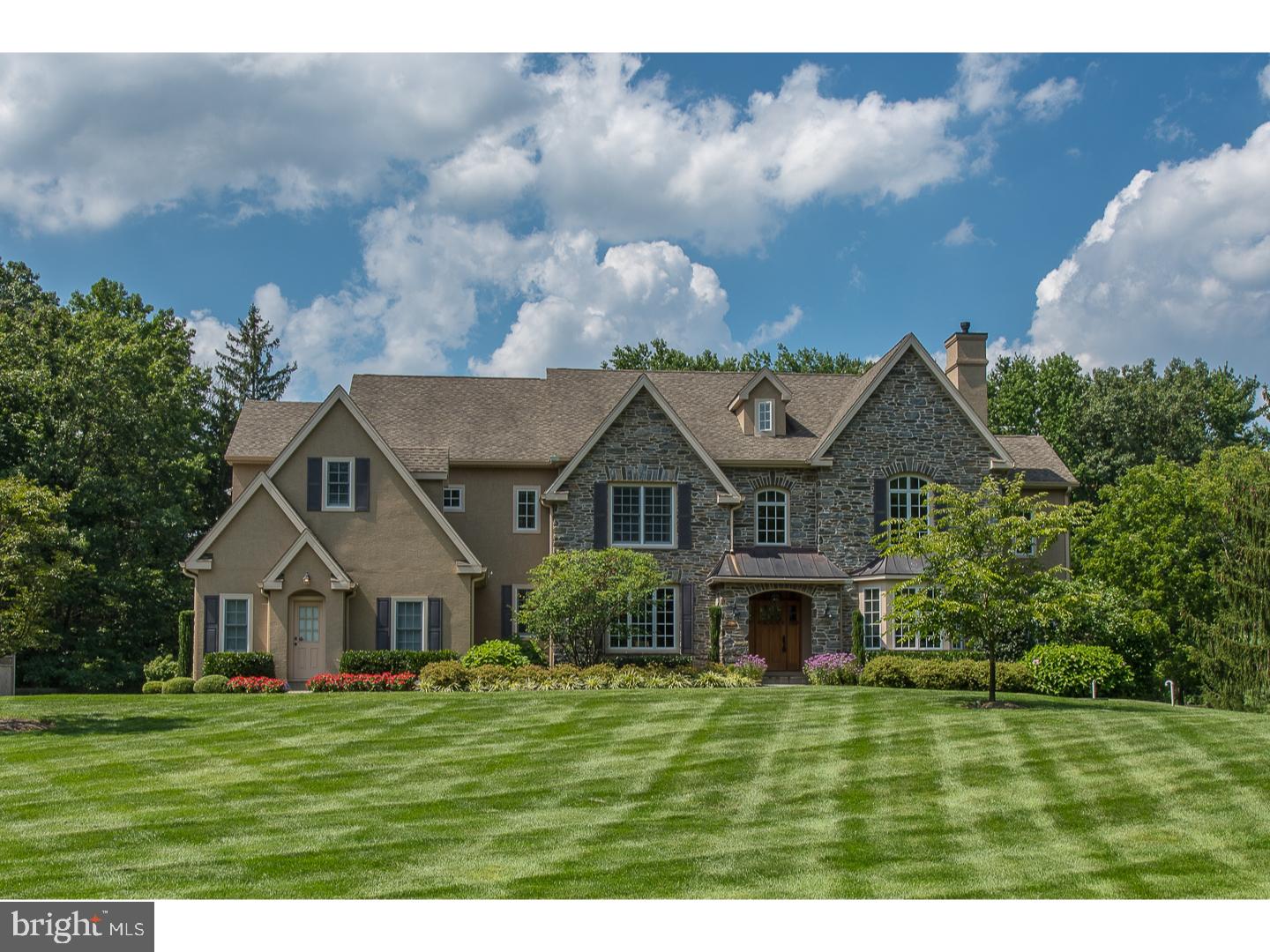 Set on an exceptional 2-acre parcel more than 200 feet from the gated entry and ringed by centennial trees for privacy, this spectacular 8,000+ square foot 9 year old home constructed by the current owner will exceed comparison to other homes of its vintage. Classic, balanced architecture with 6-inch stone construction pairs beautifully with fresh, bright and polished interior selections. With every detail carefully considered and executed, this home features highest-end finishes including Joanne Hudson Downsview custom Kitchen with large seated center island with thick reclaimed chestnut wood top and surrounding stone counters. A volume Family Room with trussed beams adds interest and three exposures of light to the informal space while a handsome office opens to the more formal living and dining room spaces. Richly stained quarter rift sawn plank floors demonstrate the homes commitment to quality while redundant heating systems, independently controlled radiant and forced air with a fresh air exchange, contribute behind the scenes to an effortless high standard of living. On the second level find an indulgent Master Suite with siting room and neutrally tiled stone bath offering an oversized seated shower, under window tub and his and her stone topped vanities. Four other generously sized bedrooms, three additional baths and large, outfitted laundry complete this floor. Finished lower level provides over 1,000 square feet of informal space including wet bar with dishwasher and refrigeration, Craft Room, large recreation area, Office, bath mechanicals and additional storage. A sophisticated outdoor entertaining space with blue stone terrace and French market lights draped over a custom pergola provides an elegant seating area while a stainless steel and stone kitchen with Lynx BBQ and granite counters is as functional as it is well planned and attractive. An angled stone fireplace with Television port above and wood storage behind, allows for four season enjoyment surrounded by flat lawn and professional landscape lighting. A stunning example of a custom home executed with vision, exemplary finishes and exceptional taste. Contact agent for additional "upgrades" and stucco evaluation.