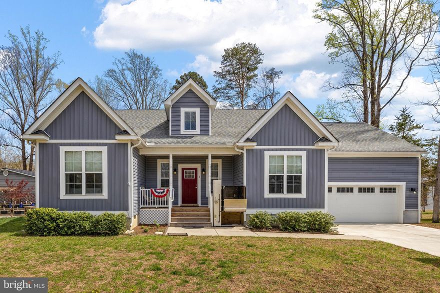 Upgrade your lifestyle and start living the lake life you’ve been dreaming of. This beautiful water-access retreat on the private side of Lake Anna offers comfort, convenience, and easy access to the water—with your very own boat slip (#2 on Pier 3) included. Designed for effortless one-level living, this home features a desirable split-bedroom layout with 3 bedrooms, 2 full baths, and over 1,850 square feet of inviting, open living space. The family room is the heart of the home, showcasing vaulted ceilings, LVP flooring, and a cozy gas fireplace that flows seamlessly into the dining area and kitchen. The kitchen features granite countertops, stainless steel appliances, and a breakfast bar perfect for casual meals or gathering with guests. A separate formal dining room adds flexibility for entertaining. The spacious primary suite offers a walk-in closet and a private en suite bath featuring a double vanity and a tiled walk-in shower. Two additional bedrooms, a full bath, and a laundry room (washer and dryer included) complete the interior. Enjoy slow mornings on the covered front porch and host unforgettable summer BBQs on the back deck after a day on the water. The property also includes a leaf guard gutter system! Two-car attached garage and a one-car detached garage—ideal for storing lake toys, a golf cart, or extra equipment—along with a paved driveway, all situated on a 0.91-acre lot. Located in the sought-after Cuckoo’s Nest community, residents enjoy golf cart-friendly living and access to one of the most amenity-rich neighborhoods on the lake. Take advantage of two expansive common areas featuring boat slips, a sandy beach, swimming areas, a boat launch, playground, picnic gazebo, and more—everything you need to enjoy the lake lifestyle! Conveniently located just minutes from local dining, groceries, and wineries/breweries, and within easy reach of Richmond, Fredericksburg, Charlottesville, and Washington D.C.  Bonus features include handicap accessibility and a chair lift for easy entry—making this home as functional as it is inviting. Come see for yourself!