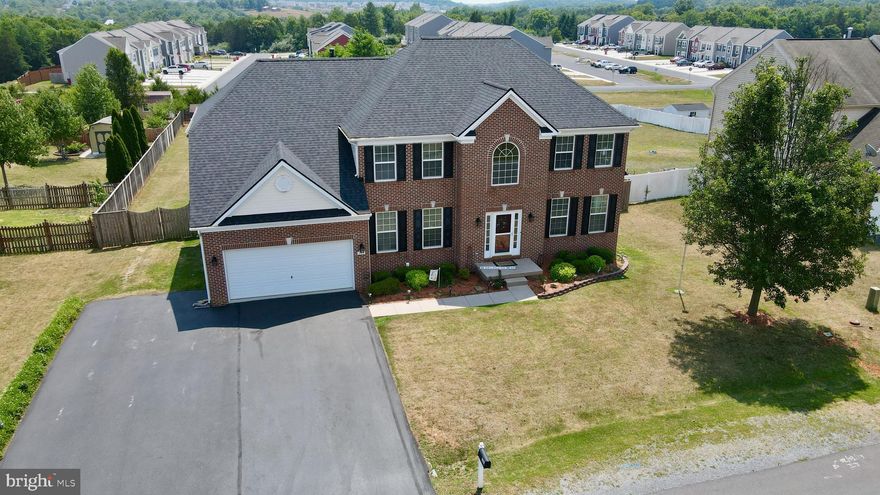 This stunning brick front colonial home, boasting four spacious bedrooms and three and a half luxurious baths, epitomizes timeless elegance combined with modern convenience. As you step through the grand entrance, you're greeted by a majestic two-story foyer, adorned with gleaming hardwood floors that exude warmth and sophistication. To the right, a cozy home office offers a tranquil space for work or study, perfectly positioned for privacy and productivity.

The formal living room is a picture of refinement, featuring intricate crown molding, a charming bay window that floods the space with natural light, and rich hardwood floors that add a touch of classic beauty. The adjoining formal dining room is equally impressive, designed to host memorable dinners and celebrations with its elegant hardwood flooring, exquisite crown molding, and stylish chair rail detailing.

Culinary enthusiasts will delight in the gourmet kitchen, which serves as the heart of the home. This chef's haven is equipped with pristine ceramic tile floors, luxurious quartz countertops, a convenient built-in desk area, and top-of-the-line stainless steel appliances. Adjacent to the kitchen, the morning room is a serene retreat with its soaring vaulted ceilings and seamless access to the back deck, making it the perfect spot for enjoying your morning coffee while basking in the morning sun.

The inviting family room, situated off the kitchen, is designed for comfort and relaxation. It features elegant hardwood floors, a cozy gas fireplace that serves as a focal point, and direct access to the rear deck, creating a seamless indoor-outdoor living experience ideal for family gatherings and entertaining guests.

The upper level is a sanctuary of comfort and luxury. The expansive primary ensuite is a private oasis, boasting a colossal walk-in closet and a lavish bathroom complete with a relaxing soaking tub and a separate shower. Three additional well-appointed bedrooms on this level share a full bath, with a convenient Jack and Jill configuration between the third and fourth bedrooms, ensuring both privacy and functionality.

The lower level of this exquisite home is a versatile space that caters to various needs and lifestyles. It includes a generously sized great room, a dedicated media room for movie nights, a bonus room, a full bathroom, and ample storage space. The expansive, fully fenced rear yard is an entertainer's dream, featuring a multi-tiered deck accessible from both the morning room and the family room. This outdoor haven is ideal for hosting summer barbecues, relaxing under the stars, or creating unforgettable memories with family and friends.

This home seamlessly blends comfort, style, and practicality, making it a perfect choice for those seeking a spacious and well-appointed residence. From its elegant interior finishes to its thoughtfully designed living spaces, this brick front colonial stands as a testament to timeless architectural beauty and modern-day convenience.