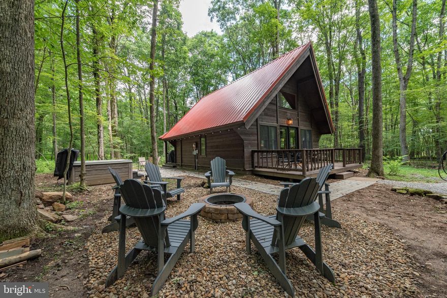 Looking for that perfect cabin in the woods basecamp? This gorgeous 2 Bedroom 2 Bathroom cabin is perfectly situated in a wooded neighborhood 5 minutes from all of the area amenities - Deep Creek Lake Marinas, Wisp Ski Resort, Swallow Falls State Park, the Community Aquatics & Recreation Complex
and much more. Currently a successful vacation rental property some of the new improvements include mini-split heat/ac units throughout, new exterior staining, new Viking Hot Tub, new firepit and hardscaping. There are many more recent upgrades (too much to add here) so contact agent for more details. This could be the  perfect cabin in the woods you've been looking for!