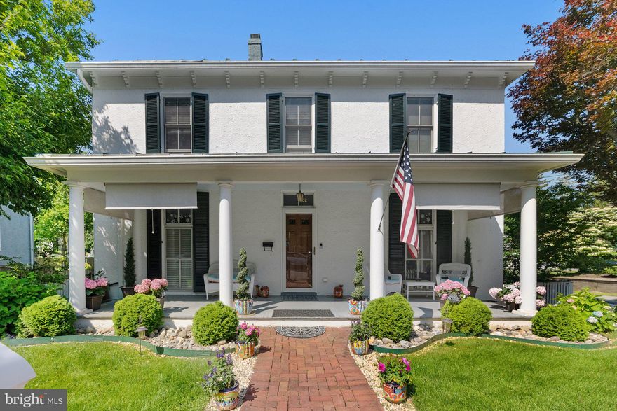 ✨ Improved Price! ✨
Step into timeless charm with this beautifully restored 1870 gem, lovingly cared for by two meticulous owners. Nestled on a picturesque corner lot along historic South Samuel Street, this home blends period elegance with thoughtful modern upgrades—inside and out.

The freshly painted stucco exterior, restored standing seam metal roof, and repointed stone foundation set the tone for what’s to come. A full-width front porch framed by graceful Doric columns invites you to pause, sip coffee, and enjoy the neighborhood’s charm. Two original 2/2/2 floor-to-ceiling windows with antique glass add to the home’s captivating curb appeal.

Inside, a gracious center hall layout on both levels brings balance and flow, highlighted by soaring 9’+ ceilings, refinished hardwood floors, and natural light at every turn. Beautiful architectural details abound—from beadboard columns with rosette moldings to transom-topped doors and an elegant front staircase.

To the left of the center hall, the Drawing Room delights with an original bay window that floods the space with light. Across the way, the spacious Dining Room features a classic fireplace and flows seamlessly into a dream-worthy Gourmet Kitchen. Complete with a large marble-topped island, upgraded stainless appliances, a gas stove, and ample cabinetry—it’s as stylish as it is functional. A sunny laundry room and charming back staircase (perfect for late-night kitchen runs!) round out the space.

The main level also includes a marble-floored half bath and a serene sunroom overlooking the backyard—both this space and its upstairs counterpart include independent LG heating/cooling units for year-round comfort.

Head downstairs to find a finished lower level made for fun and relaxation! You'll love the cozy ambiance created by laminate plank flooring and propane fireplaces. There’s a pool room with a fireplace mantle reclaimed from the Carriage House, a game room ready for ping pong or darts, and a generous unfinished area for storage.

Upstairs, the spacious primary suite offers a spa-like retreat with a marble bathroom, walk-in shower, double vanity, and excellent storage. Two additional bedrooms offer unique charm—one with generous closets, the other with an original built-in. A stylish guest bath with marble finishes and a vintage clawfoot tub completes the second level.

Outside, your private backyard oasis awaits! Discover thoughtfully landscaped gardens with stone enclaves, winding brick paths, a stamped dark rose concrete patio, and a new Cabana. There’s even a newly built 12x12 Hot House and a vintage Carriage House—both with electricity and prepped for future generator hookup.

Just a short stroll from the heart of downtown Charles Town, you’re close to local shops, eateries, and the seasonal farmers market. Nature lovers and history buffs will adore nearby Harpers Ferry and the area's abundant outdoor adventures. Plus, with easy access to Virginia and Maryland commuter routes, it’s perfectly positioned for work and play.

Home is listed in the National Register of Historic Places as a contributing building in the Charles Town Residential Historic District. This rare find is a harmonious blend of past and present, ready to welcome its next chapter.

Don’t miss the chance to make this storybook home yours!