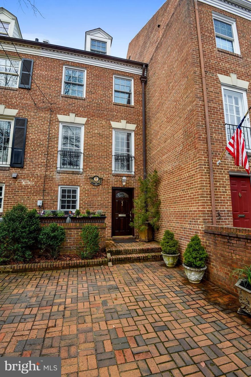 NEW PRICE!!  Brick paved private parking at the front entrance provides easy access to your retreat after a long day at the office and invites your guests to enter the solid mahogany front door, surrounded by patina covered copper gutters and downspout into a home reflective of colonial era Old Town.   Upon entry, early 19th century style raised panel wainscoting topped by used brick and colonial crown molding greets the eye in the spacious slate floored foyer.  Antique doorknobs and locking plates entice you to open the 6-glass pane French doors to explore the ground floor bedroom and adjoining powder room.  The commanding 9  ceilings and built-in bookcases in the Living Room frame the stained walnut gothic fireplace surround as two twin glassed French doors beckon to the private retreat at the rear of the property.  This refreshing garden showcases raised brick planters, with a tumbled blue stone walkway leading to the preserved natural cedar fence gate that opens to the rear easement.  Moss covered boulders form a dry creek bed sheltered by Japanese maples and a mature juniper accented by red crepe myrtle and tall evergreens.  The soft flowing ripples of the three-tiered Italian-styled fountain sings a melodious tune beneath the master bedroom window.Elegantly lit by a center hung antique 2-tier, 20-light, 112 crystal chandelier beneath a circular acanthus leaf medallion showcased by recessed dimmable mood lighting, the Dining Room presents the perfect setting to entertain friends and neighbors.  Colonial 3-Piece dental crown molding with French gallery trim allows the art collector to rotate the display of artwork without marking the walls.Beneath tall, custom distressed ash cabinets, the soft glow of dimmable under-cabinet LED lighting enhances the gourmet Kitchen with countertops of ogee edged granite, accented with a picture framed slate and travertine backsplash.  Top of the line appliances include the gun metal stainless finish of the oven, microwave/convection oven, glass cooktop with vent hood and warming drawer by Wolf, the side-by-side 48  Subzero refrigerator/freezer, and the Fisher&Paykel Double DishDrawer dishwasher.  Store and display your favorite cookbooks behind the antique glass front of the over counter cabinet.  For the sommelier, the in-kitchen bar with antique glass doored wine rack holds 48 bottles of your favorite vintage and protect and display your flutes and wine glasses in the 7 row under cabinet stemware holder.  The well-lit spacious center island comfortably seats 4.Roughhewn beams and stucco textured walls in the Kitchen and brick walled Family Room compliment the stone hearth of the second woodburning fireplace, which promises intimate warm moments during the cold winter months.The open stairwell sports Victorian metal grates for the HVAC returns and register covers adding a distinctive charm and refinement to the natural finished wide plank Southern Yellow Pine floors throughout this impressive home. All windows and French Doors on upper levels have been replaced.Be transported to your own private Grecian spa in both the Master and main bathrooms, appointed with travertine floors, wainscoting, 3-piece mosaic chair rail and 2-piece crown surrounds.  The upper three bedrooms provide ample closet space for the most discerning wardrobe and render peaceful views with natural light.Climb past a 19th century armoire front covering the air handler unit, to the private suite containing a large fourth bedroom, full bath and laundry closet  with Whirlpool Duet Steam washer and dryer on pedestal storage drawers.  Additional easy access extra storage space is provided by four under-dormer closets and a full footprint attic all floored and lighted. Located just 2   blocks from the restaurants, shops, and galleries along King Street and just 4 blocks from the Potomac River waterfront, this home is an easy stroll to the many city parks and historic sites that this charming town has to offer.