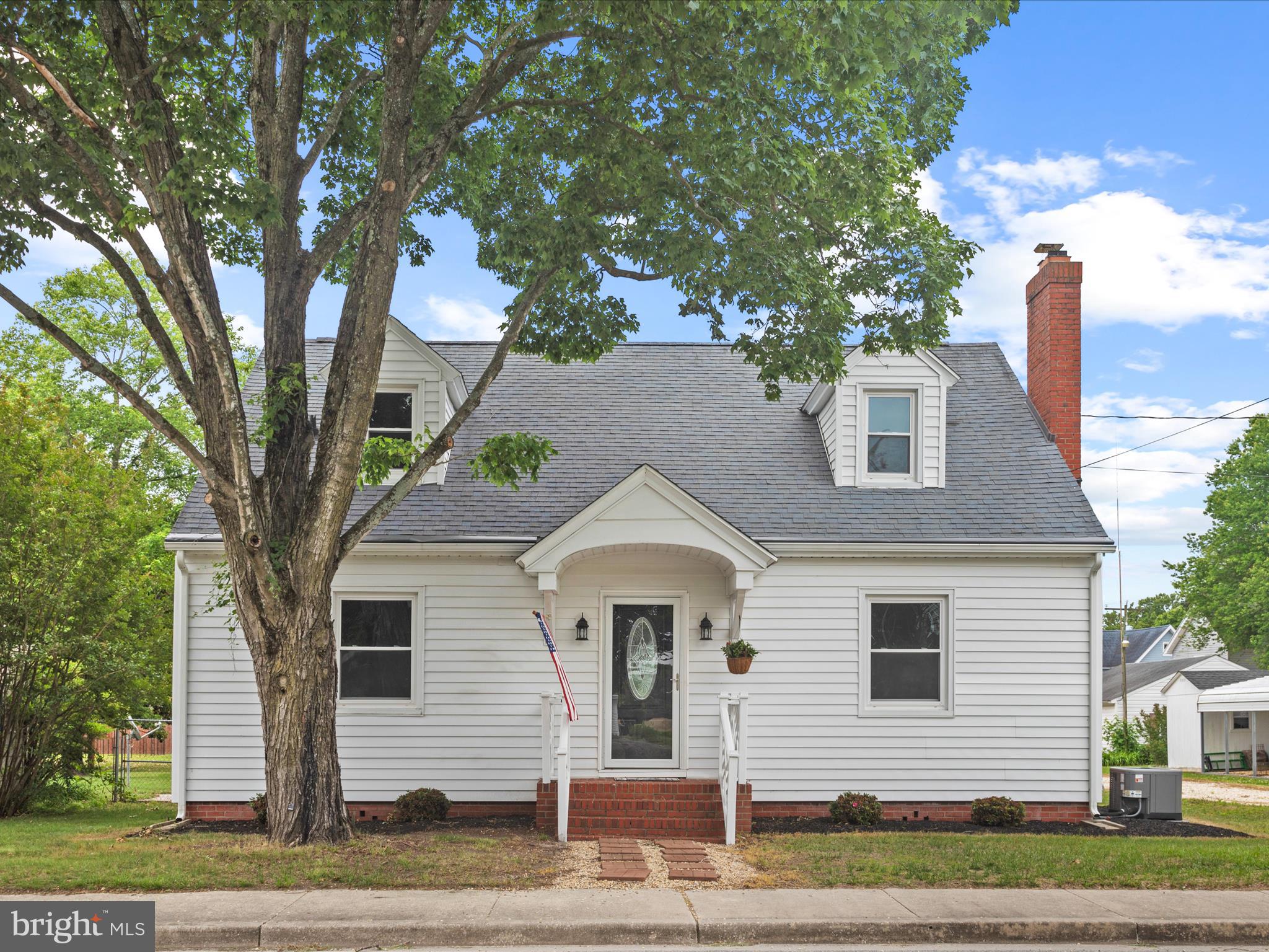 Welcome to this beautifully remodeled 1947 Cape Cod-style home, where timeless charm meets modern convenience. With just under 1 ,700 square feet of thoughtfully designed living space, this home offers the perfect balance of classic character and stylish, contemporary upgrades. As you step inside, you'll immediately notice the bright and airy atmosphere, enhanced by large windows and an open floor plan that seamlessly connects the living and dining areas. The spacious living room features warm originally restored hardwood floors, a cozy wood burning fireplace, and oversized trim moldings, providing a perfect space for both relaxation and entertaining. The fully renovated kitchen boasts sleek granite countertops, stainless steel appliances, ample cabinet space, and first floor conveniently accessible utilities. Whether you're preparing a casual meal or hosting a dinner party, this kitchen offers both function and beauty. The main floor includes solid wood doors throughout and restored hardware, two generously sized bedrooms with closet space and large windows that let in natural light. The remodeled bathroom features modern fixtures, and a handicap accessible shower. Upstairs, you'll find a charming primary or third bedroom with private bathroom and attached closet. Views of the surrounding neighborhood make it an ideal space for a private retreat or home office. Step outside to the fully fenced backyard where pets are free to roam from the comfort of your back door. A detached garage with a new roof and insulated indoor/outdoor addition provides a flexible space for car parking, gardening, cycling, tools, storage, and many other interests or hobbies. This home is just minutes from the local carnival, shops, dining, parks, and schools. Don't miss the opportunity to own a piece of history with all the comforts of modern living. Schedule your tour today!