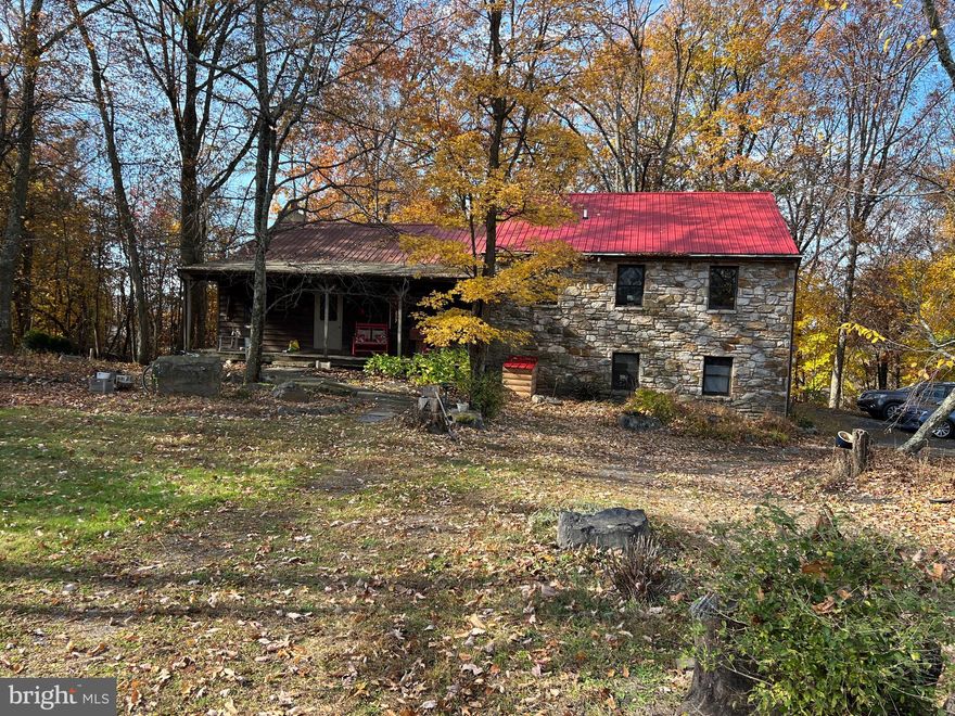 Wow!!  This custom-designed house was built by Donnie Heimbach for the original and current owner.s.  The setting is superb amongst the wooded lands and a great hideaway for wildlife!  Some of the many features include 4-Bedrooms, 3 Bathrooms, random Oak Hardwood Flooring, Cathedral wood ceilings, Living Room with a floor to ceiling stone Fireplace, Family Room with direct access to the exterior,  Office/Den, a covered Front Porch about 31’ long, a rear screened-in porch measuring about 12’ x 16’, an open deck measuring about 12’ x 16, multiple Outbuildings, plus a huge Steel Building measuring about 80’ x 100’ of which about 40’ x 40’ is insulated, all situate on over 6+ wooded and opened acres in a tranquil setting.  Please note there is approximately 2,800 +/- square feet of living space.  Owners are requesting a minimum 90-day settlement.  Please note that all numbers, dimensions, and measurements contained herein are approximations only.  Buyer should verify the same, in order to satisfy self.