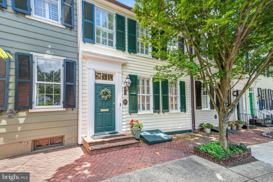 Don’t miss this rare opportunity to own a pristine historic home on South Fairfax Street in the Southeast quadrant of Old Town Alexandria! Built in 1820, this beautiful home has been meticulously maintained and updated while retaining many original features, including the two staircases. Enter into a formal foyer with a conveniently located coat closet and half bath.  The gracious living room showcases a gas fireplace, detailed moldings, abundant natural light from the two front windows, and the French doors leading to the side garden.  A dry bar, in the hyphen hall leading to the dining room, has a chic mirrored backsplash and wine cooler. The separate dining room is lined with windows on the south side and has a decorative fireplace.  Beyond, the family room is the heart of the home with a kitchen, family room, and breakfast room overlooking the stunning garden.  The cozy family room has a fireplace and custom built-in cabinets for storage and display.  The gourmet kitchen is both functional and atheistically pleasing with painted cabinets, hidden appliance storage, a gas range, and ample counter space. The adjoining breakfast nook has additional custom built-ins and access to the garden. The second level is home to 3 bedrooms and 2 full baths. The spacious primary suite features a dressing room with multiple closets and an en suite bath. The second bedroom is awash with natural light from a skylight and numerous windows and has the fourth fireplace in the home.  This space can easily be an office with a custom built-in desk area.  The third bedroom, with vaulted ceilings, is accessible from the second floor or the back staircase and also boasts built-ins for additional storage, and a lovely window with plantation shutters looking out towards the lush green garden.  The second full bath has been recently remodeled and is accessible from both bedrooms. One of the many highlights is the expansive private garden oasis; this professionally designed space is full of mature specimens, contains multiple seating and entertaining areas, and has shed storage and alley access.  Offered in move-in condition and a premier location, your dream house is just steps from shops, restaurants, parks, and the waterfront.