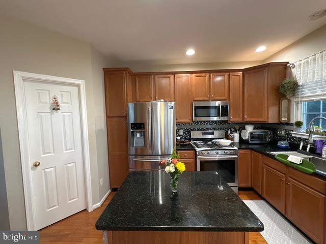 Cozy and bright townhouse with two master suites. Lower level has a den/office. Stylishly updated kitchen leads to good good-sized deck. End unit with convenient street parking in front of the house. Enjoy Belmont Land Bay amenities.