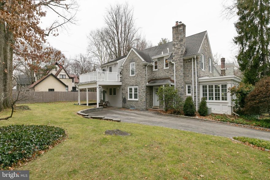 Welcome home to this 4 bedroom, 3 full & 2 half bath Center Hall Stone Colonial in the heart of Merion Park. These quiet, tree-lined streets are located at the base of the Main Line, but only minutes to Center City. Walk into Narberth for a coffee, pastry or a pint or to General Wayne Park for some fresh air, a baseball game or tennis lesson.

Park your car in the private driveway and hookup to your Tesla charger before you walk into the bright and open foyer with gorgeous hardwood floors. On the first floor you’ll have your choice to unwind in the formal living room with wood burning fireplace, the window-filled sunporch or the large and open great room with gas fireplace. The home is wired for sound and ready for entertaining. The open concept kitchen, which utilizes the original stone wall for a pass-through window to the dining room has updated stainless steel appliances, granite countertops and solid Woodmode cabinetry. The radiant heat floors in the basement give you yet another option for a cozy space to relax, or to build out your ideal home gym.

The upper floor boasts 4 large bedrooms and 3 full baths. 2 en-suite bedrooms with walk-in closets and private baths. The primary bedroom is built to pamper you with radiant heat floors in the limestone tiled bath, steam shower, dual vanity, linen closet and laundry chute, a large walk-in closet, vaulted ceilings and a private balcony over the carport to enjoy the morning sunshine.

Outside, the lot has been levelled and landscaped. There are two entertaining areas with beautiful stone hardscape. The grill is set for the home chef with a natural gas line for endless cooking.
