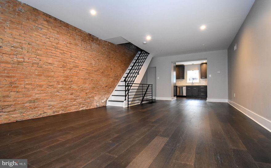 Exciting rehab in Newbold! No developer is more thoughtful than this one. Focused on each detail from sturdy door stops, washer dryer, hall closet on second floor, shower niche, carved nooks, and finished utility closets. Upon first step through the dramatic front doorway, you're immediately greeted with warmth and comfort resonating from the restored exposed brick and upgraded water proofed engineered vinyl flooring. This open concept living room has expansive space with graceful taste. The extended home gifts you the space of a sizable kitchen with 42 inch cabinets and  floor to ceiling pantry s! Through the back of the kitchen is your concrete yard to enjoy as you please. Up the chic stairwell lead you right to the masterfully crafted main bathroom. Boasting floor to ceiling large tile work, shower niche and double wide vanity. Don't forget the well lit and cozy back bedroom. Down the hall and to the front is your generously sized master bedroom just beyond the tucked away hall closet with rod. This master bedroom rivals any two bed like it in the area. Plenty of dimension to set up the way you want! To the basement is your bonus room with plenty of head room, luxury tiles laid out and a half bath. Right next to is the Speed Queen washer dryer included with the home! Don't miss this great home, all that's missing is you...