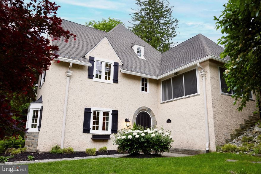 Nestled in a charming cul-de-sac in the heart of Northside Bryn Mawr, this updated 3-story home is situated in one of the area's most coveted neighborhoods. The residence effortlessly combines classic elegance with modern convenience, featuring 4-5 spacious bedrooms, 3 full bathrooms, and a half bath, making it ideal for both family living and entertaining.
Upon entry, an impressive two-story foyer welcomes you, filled with natural light that sets the tone for the elegance and character throughout. The gracious dining room, accented by a large bay window with a window seat, flows into the renovated kitchen. This culinary space is a chef's delight, with a large center island, stainless steel appliances, including a commercial range, ample storage, and plenty of windows. Adjacent to the kitchen, you'll find a practical laundry area with a sink and a sizable closet- easily used as a mudroom. Through the back hallway from the kitchen is the “workshop,” which could alternatively be used as an office, den or playroom, as well as a conveniently located powder room, basement, and backstairs access.
Up the front stairs to the right is a screened porch with tile floors providing easy access to the fenced backyard, featuring a large patio adjacent to a pond with a zen waterfall. To the left is the grand living room with stunning stone-surround fireplace with a wood mantle, many large windows exposing the beautifully landscaped rear yard, and an overlook to the entry hall surrounded by thoughtfully crafted arched wood framework, viewing a chandelier and light-catching stained-glass window.
Ascending a few steps and around to the left is the private primary bedroom level, which includes a sunlit primary suite with two closets and an updated ensuite bath. This floor includes two additional generously sized bedrooms, one currently used as a library with built-ins, and a renovated full bath. Through the library is a charming private stairway leading to a 3rd floor bedroom suite with private renovated bath.
Climb the primary stairs to an expansive additional bedroom or media room with two large closets and large windows overlooking the manicured yard. Further at the top of the stairs is a bonus room adjoining the attic, currently used for storage.
This exceptional home features hardwood floors throughout, abundant closet and storage space, and exudes style and charm. It's conveniently located within walking distance of the Bryn Mawr train station, local restaurants, the Ludington library, Bryn Mawr Hospital and just minutes from all the Main Line has to offer.
Showings will begin at the open house on Friday, 5/16, 4-6pm.  Agents may make appointments anytime during or after that time.