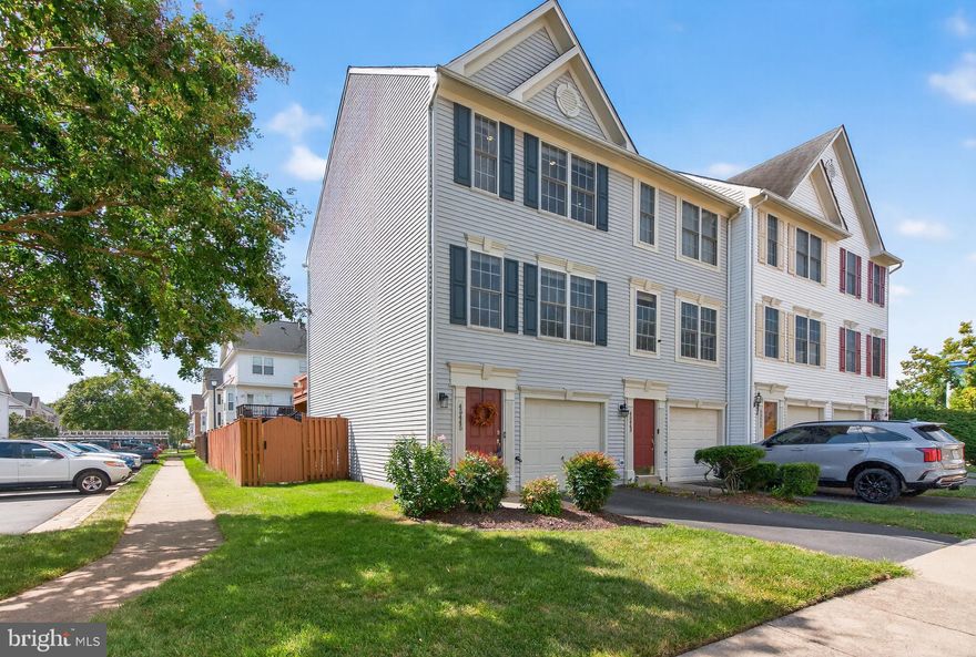 Welcome to this stunning 3-bed, 2.5 bath end-unit townhome within the sought-after Trailside community in Sterling. Combining modern style with everyday comfort, this home offers a peaceful retreat with low HOA fees and a prime location. The main level provides a welcoming space to entertain or unwind, featuring ample natural lighting and luxury plank flooring throughout. The beautifully updated kitchen boasts white shaker-style cabinetry, quartz countertops, a classic subway tile backsplash, stainless steel appliances, and an adjoining dining area. Cozy up near the gas fireplace in the spacious family room that opens to a newly painted deck (2025) complete with a built-in bench, ideal for everyday enjoyment. A stylish and fully updated powder room is conveniently located on this level. Upstairs, two generous bedrooms shared a spa-inspired bathroom with a glass-enclosed shower, dual vanity, and jacuzzi-style soaking tub. The primary suite is enhanced with vaulted ceilings and excellent wardrobe space. The lower level adds versatility with a third bedroom offering direct rear yard access, a full bath, and a laundry room—perfect as a guest suite, in-home office, or additional living space. Outdoors, the large fenced yard provides space for everyone to enjoy, while the stone-paved patio is great for relaxed gatherings. Parking is effortless with an attached one-car garage, driveway space, and additional visitor passes. Recent updates include roof (2024), water heater (2023), HVAC (2017), staircase handrail stained (2025), updated showerheads in both bathrooms (2023), and recessed lighting with dimmers in secondary bedrooms (2023). Backing onto the W&OD Trail, this home enjoys an excellent location just minutes from major commuting routes and local amenities, including Wegmans, Target, Claude Moore Recreation Centre and Park, Innovation Center Metro, and Dulles Airport.