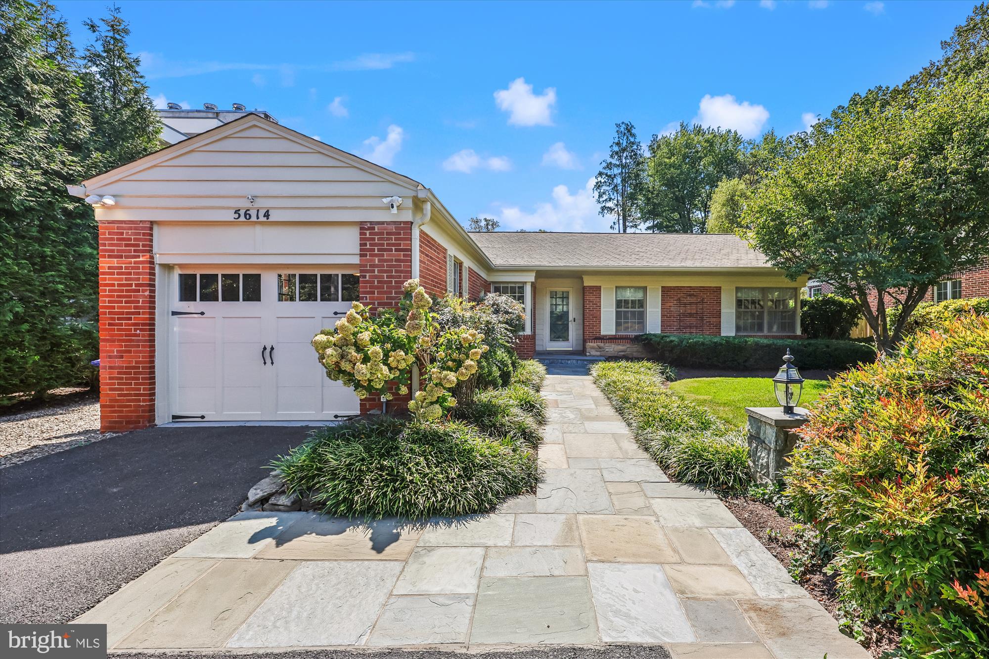 Tucked into one of Bethesda’s most coveted close-in neighborhoods—where charming original homes share the block with striking new builds—this well-cared-for 1950s rambler with 3 bedrooms and 3 full bathrooms offers the best of both worlds: move-in comfort today and exciting potential for tomorrow. Set on a gorgeous fenced lot less than a mile to downtown Bethesda, the home blends classic character with thoughtful updates: gleaming hardwood floors, recessed lighting, a large family room addition, two fireplaces, a finished basement, and an attached one-car garage. Whether you’re dreaming of turnkey one-level living or envisioning a custom transformation in a prime location, this property is a rare find. From the moment you arrive, the curb appeal stands out. Mature trees, tidy landscaping, and a welcoming front walk highlight the timeless brick exterior. The wide, level lot is fully fenced in the rear, offering a practical and inviting outdoor backdrop. There’s ample space for entertaining, gardening, pets, or play. Because many surrounding properties have already been expanded or rebuilt, you’ll feel right at home whether you enjoy the house as-is or join the trend toward larger, high-end residences. Inside, the home reflects its 1950s roots while embracing modern updates. The foyer opens to a sun-filled living room anchored by the first of two fireplaces, creating a warm setting for cozy evenings or casual gatherings. Hardwood floors shine under natural light, while recessed lighting ensures every corner feels bright and cheerful. The standout feature is the large family room addition at the rear—a space that could accommodate a big sectional, media area, game corner, or casual dining spot. With broad windows overlooking the backyard, this room functions as the home’s hub, seamlessly connecting indoor comfort with outdoor fun. The adjacent kitchen balances function and opportunity. Solid birch cabinetry, ample corian counter space, and efficient layout make cooking easy, while its placement near the family, dining, and living rooms keeps everyone connected. Long term, it’s ideally situated for an open-concept redesign should you wish. Three comfortable main-level bedrooms are tucked along a quiet hall. The spacious, primary suite features an en-suite bath renovated three years ago. Two additional bedrooms offer flexibility for guests, office, or nursery. The hall bath, renovated five years ago, serves these rooms well. Move-in ready today and all neutral finishes. The finished basement expands the home’s versatility. Here, the second fireplace sets the tone for a spacious recreation room, perfect for movies, play, or hobbies. There’s plenty of room for a gym or home office setup, plus another renovated full bathroom, generous storage and a dedicated laundry room. An attached one-car garage is a real bonus in this close-in location, offering covered parking and extra storage. The driveway adds more parking, plentiful for guests. This property is equal parts charming and practical. Recessed lighting, hardwood floors, and updated baths blend seamlessly with its classic character, while the wide lot and location provide outstanding long-term potential. Just a short stroll to downtown Bethesda shops, restaurants, parks, and Metro, this home combines convenience, comfort, and opportunity in one of the area’s most desirable settings. If you’ve been waiting for a close-in Bethesda home that delivers location, livability, and long-term upside, this is it! Homes in this pocket don’t come along often—especially those that balance turnkey ease with renovation potential.