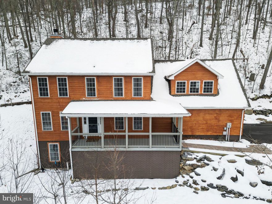 As you approach this home, the gently winding driveway leads you through the two-car garage and inside, where you'll be drawn straight up the stairs to the loft. The breathtaking views from this space will inspire you. Whether you're an artist seeking creative sparks or someone in need of a playroom, craft space, or anything else your heart desires, this room offers endless possibilities.

Back on the main level, hardwood floors flow throughout much of the living area, creating a warm and inviting atmosphere. The spacious eat-in kitchen boasts ample counter space, with a breakfast bar perfect for starting your day. A walk-in pantry with shelving also includes convenient washer/dryer hookups for those who prefer main-level laundry. Sliding glass doors open to a covered deck, offering views of your fenced yard—and best of all, there are no houses behind you.

Off the kitchen, a stunning stone wood-burning fireplace will keep you cozy, while a separate dining room provides an ideal spot to gather for family meals.

Upstairs, the primary suite features its own expansive covered balcony, offering plenty of privacy to enjoy a morning cup of coffee or unwind with a glass of wine after a busy day. The ensuite bath includes a jetted soaking tub, separate shower, double sinks, and a large walk-in closet tucked in the back corner. Two well-sized bedrooms share a full hall bath, with an additional space between them perfect for a desk or reading nook.

The walkout basement offers a family room, the potential for a 4th bedroom with an attached full bath, and a storage room with a laundry area. There's also a fantastic bonus room waiting for your imagination to transform it into whatever you need.

The home sits on state-maintained, mostly paved roads in this lovely Shannondale location. The surround sound system, Blu-ray player, and generator switch-over panel are included. This home is just 1/4 mile from the Appalachian Trail and close to the Mountain Lake Club, a great spot to enjoy the outdoors or grab a bite to eat. If you're seeking peace and privacy, this is your perfect sanctuary away from the noise. Your private oasis is ready and waiting—will you answer the call?